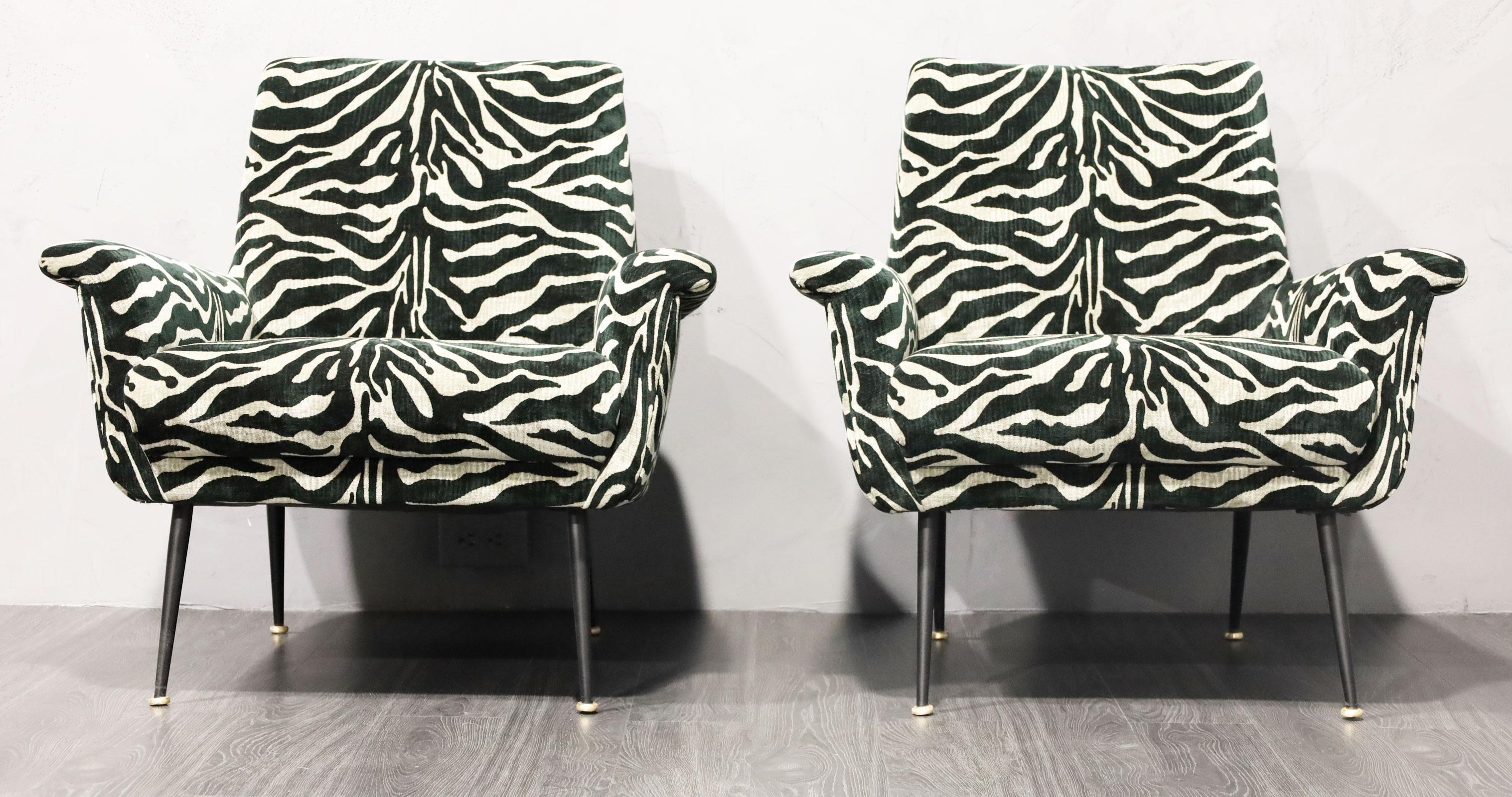 A black/gray animal print velvet/chenille upholstery with refinished metal legs with brass caps.  Beautiful pattern and high drama for any room.  Chairs are comfortable as well. 