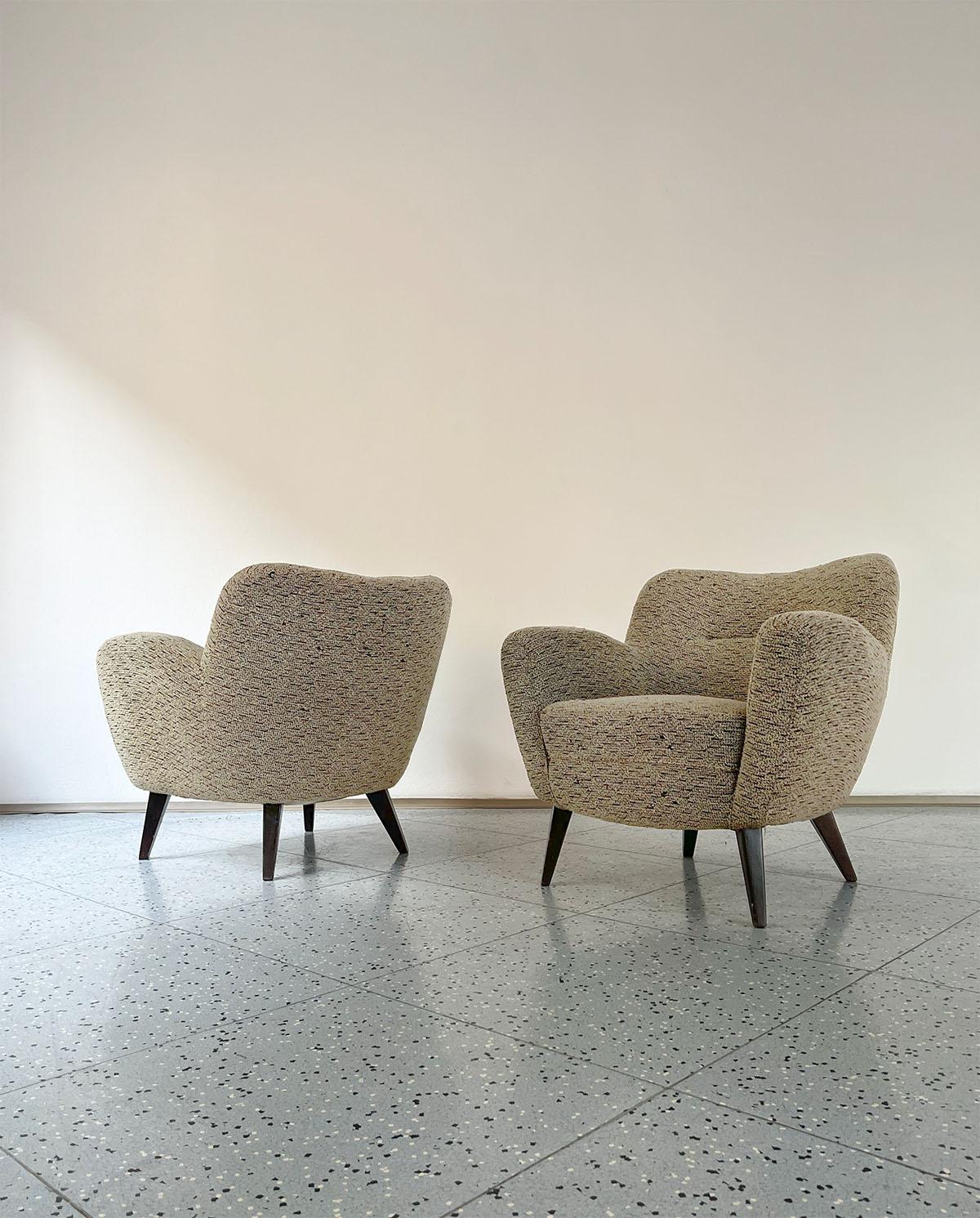 Pair of French lounge chairs in oak and bouclé fabric, made in France, 1950s.

With their slightly round shape, these chairs look absolutely gorgeous, especially in their original light bouclé fabric, which contrasts with the dark oak