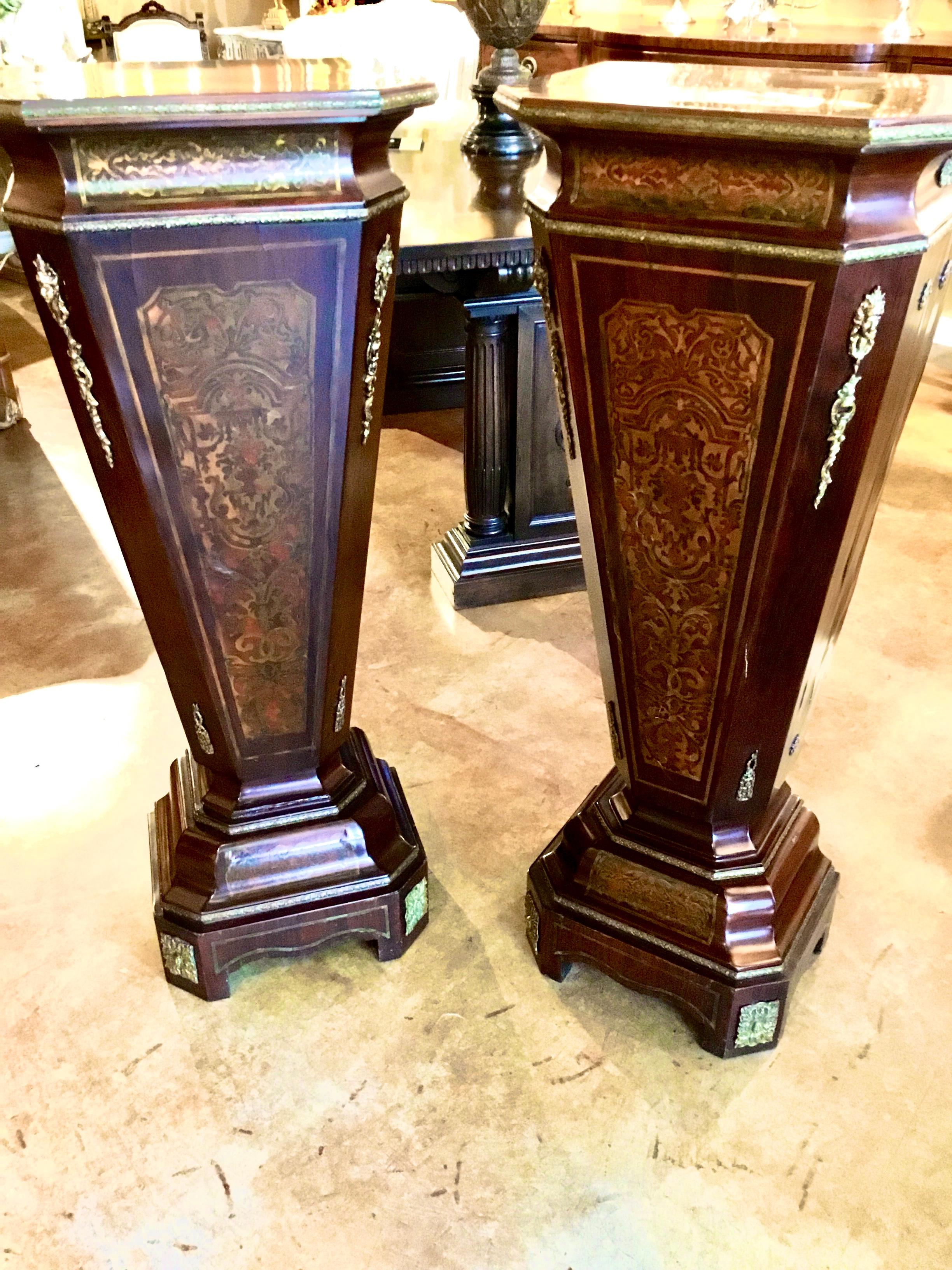 Exceptional pair of antique boulle pedestals with bronze mounts and brass inlaid 
Decorations. Elegant tapering shape with bases that have canted shape.