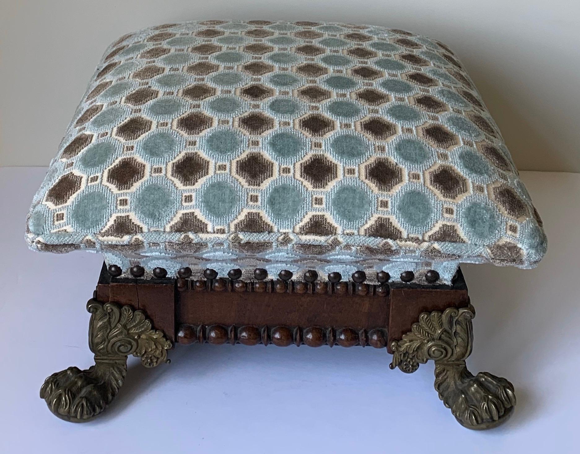 Pair of 1890s French mahogany footstools with splayed solid brass ball and claw feet. Newly upholstered in Highland Court cut velvet with nailhead detailing.