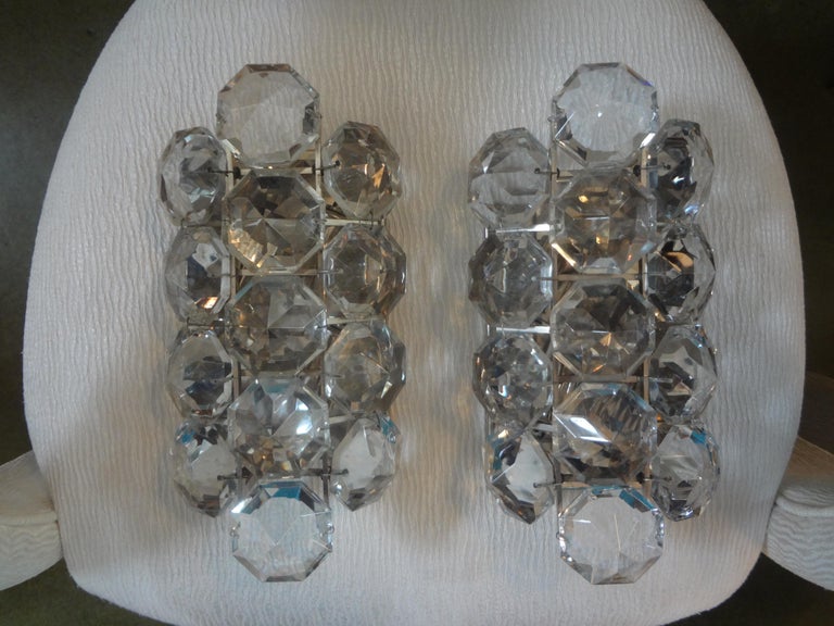 Pair Of French Maison Baguès crystal prism sconces. This stunning pair of French Bagues are comprised of large 2.5 inch glass prisms. These sconces are newly wired each with three new American sockets and ready for installation.