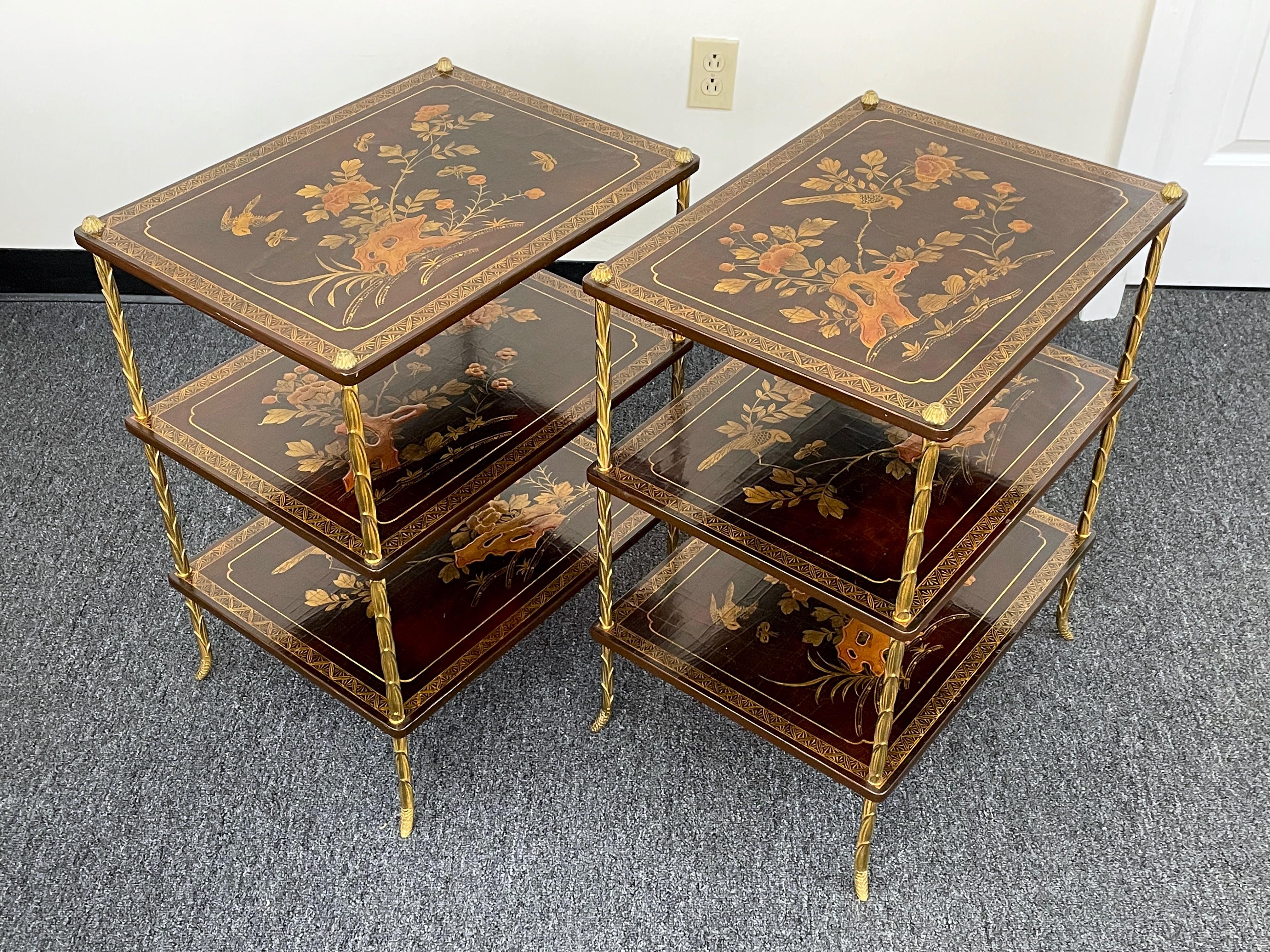 A rare pair of stunning French gilt-bronze and Chinoiserie top side tables with three tiers (attributed to Maison Baguès, mid-Century). Each table has three rectangular burgundy-lacquered tops decorated in the Chinoiserie style with each top having