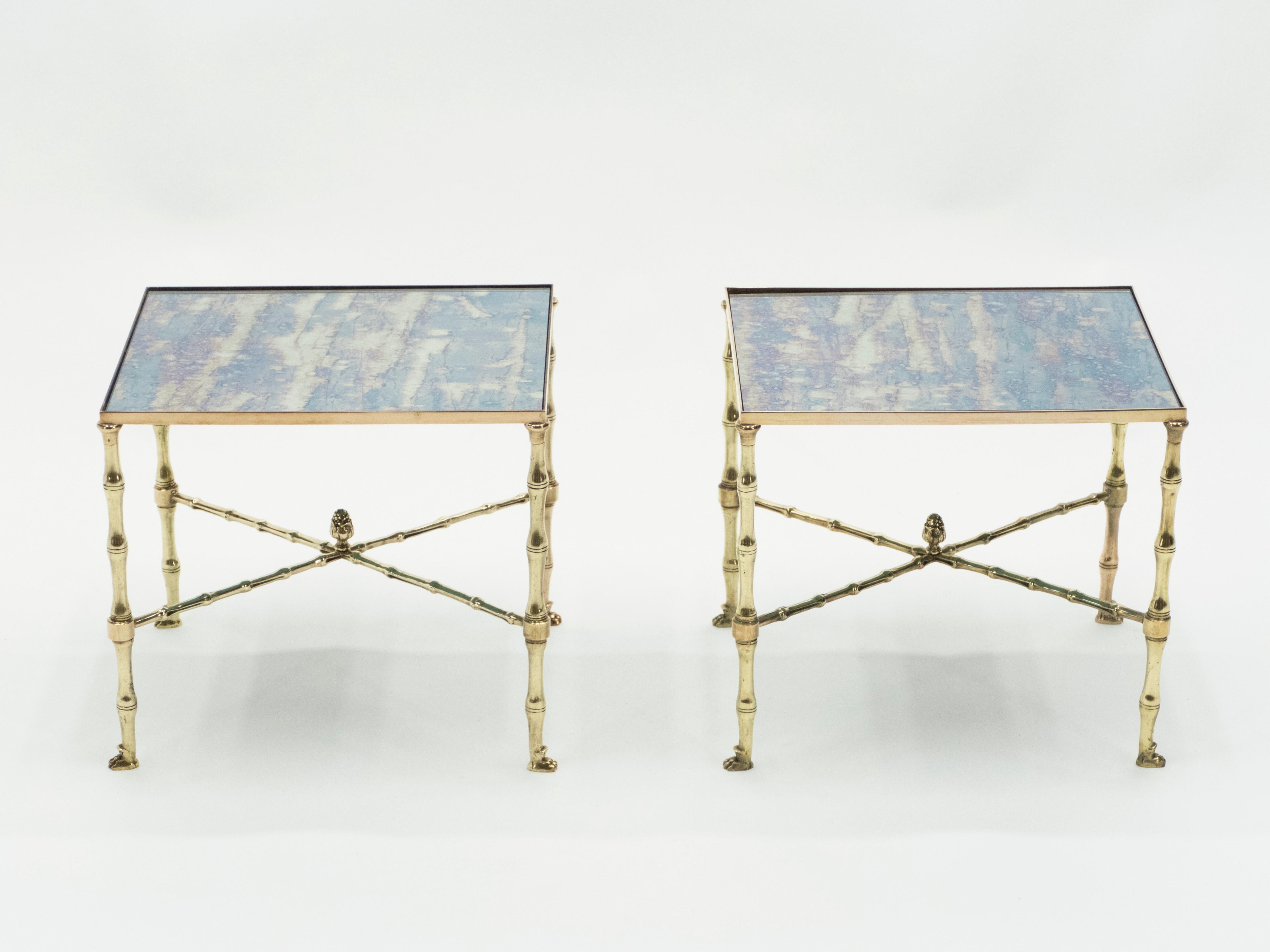 This pair of end tables by French design house Maison Jansen was created with solid brass and typical French neoclassical brass bamboo, pine cone, lion paw and old patina mirror, circa 1960. The old patina mirrored top is smooth, while the brass