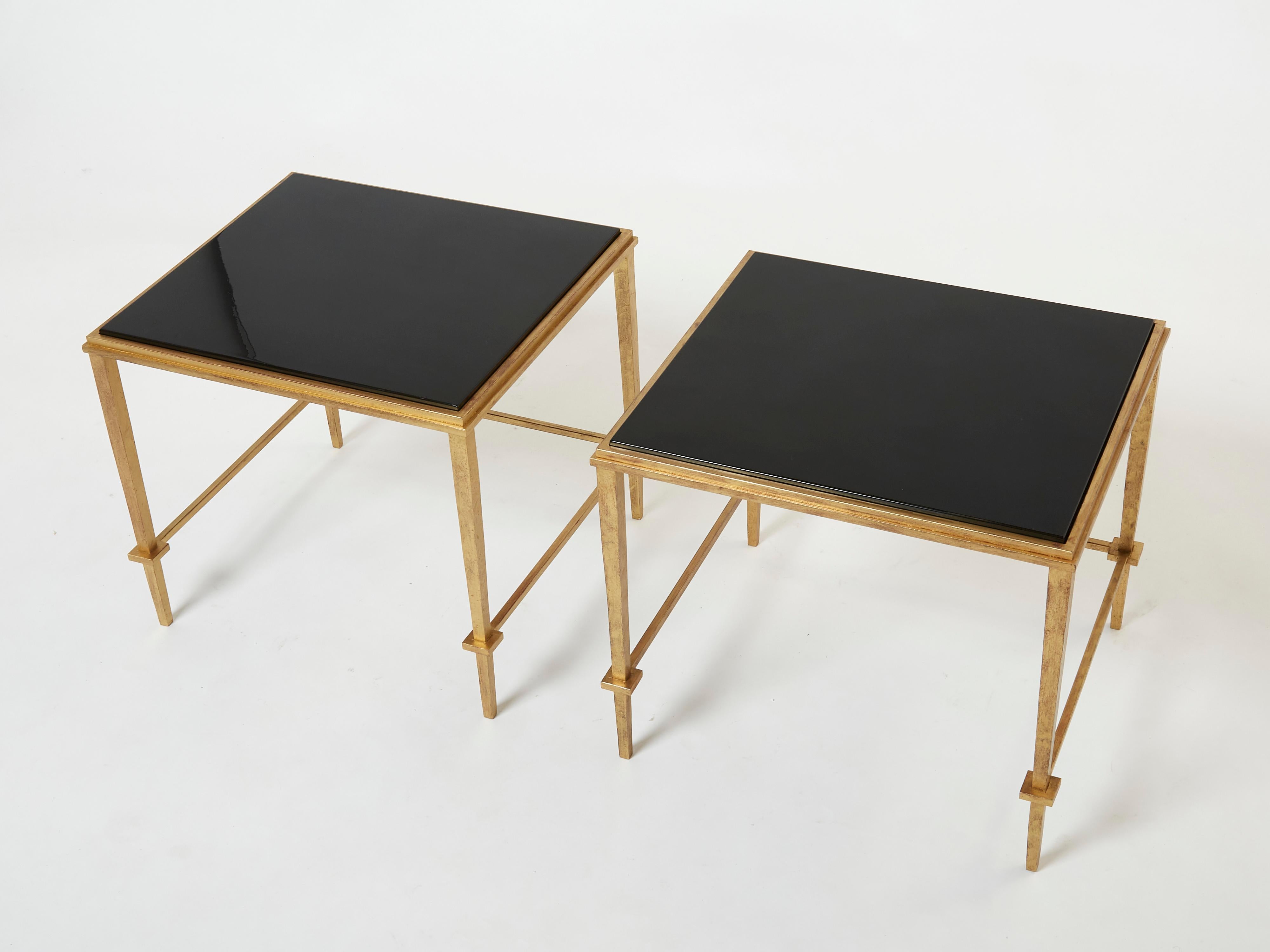 This beautiful pair of end tables, or side tables, by Maison Ramsay are from the 1950s, and carry with them the elegant mood of the neoclassical post art deco period. The wrought iron feet are glittering in an antiqued gold gilt finish, while the