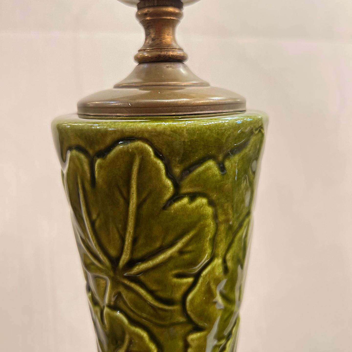 A pair of circa 1940s French Majolica porcelain in green glaze with foliage motif.

Measurements:
Height of body: 22