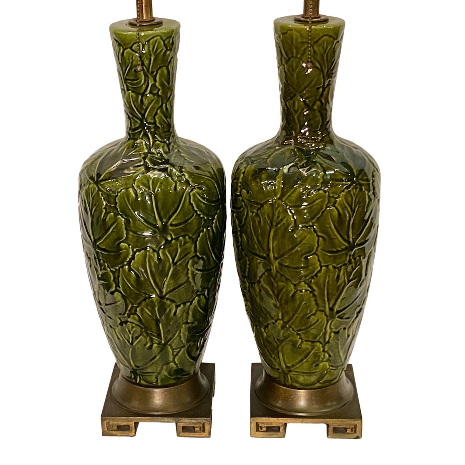 A pair of circa 1940's French majolica porcelain in green glaze with foliage motif.

Measurements:
Height of body: 22