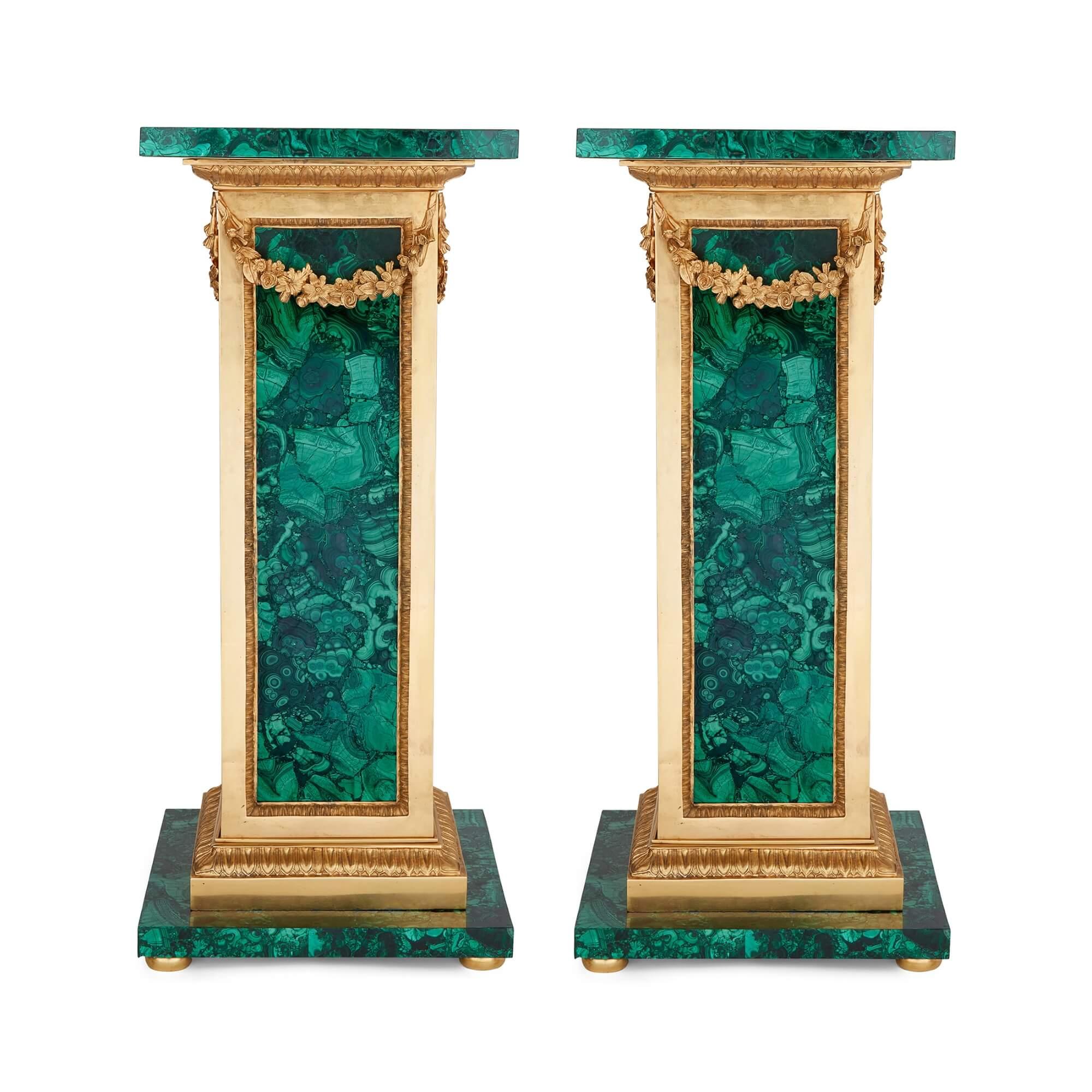 Pair of French malachite and ormolu pedestals 
French, 20th Century
Height 102cm, width 44cm, depth 44cm 

Elegantly mounted with ormolu features and fully covered in malachite, this pair of pedestals is guaranteed to add a touch of elegance to the