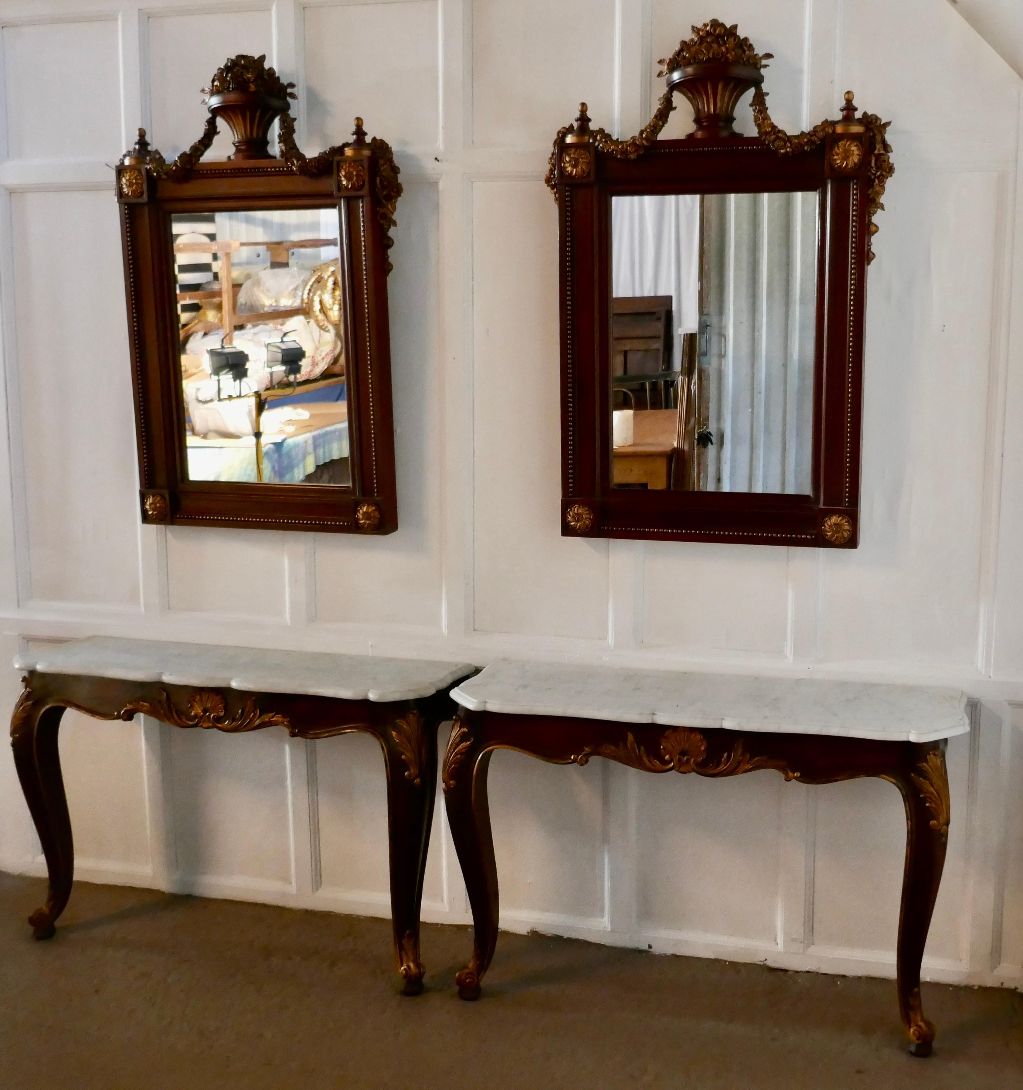 Pair of French marble-top console tables with mirrors

This is a very attractive pair, the tables are 19th century and carved in mahogany with shaped marble tops, we have matched them with a pair of 20th century carved mirrors, both come from