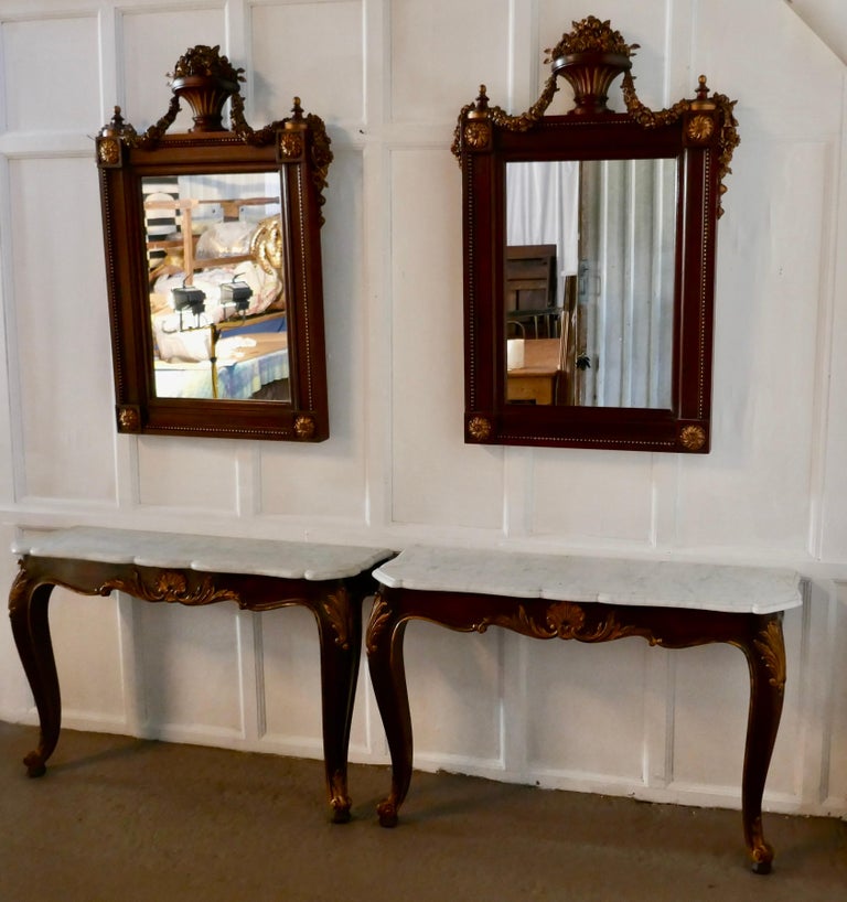 Pair of French marble-top console tables with mirrors

This is a very attractive pair, the tables are 19th century and carved in mahogany with shaped marble tops, we have matched them with a pair of 20th century carved mirrors, both come from