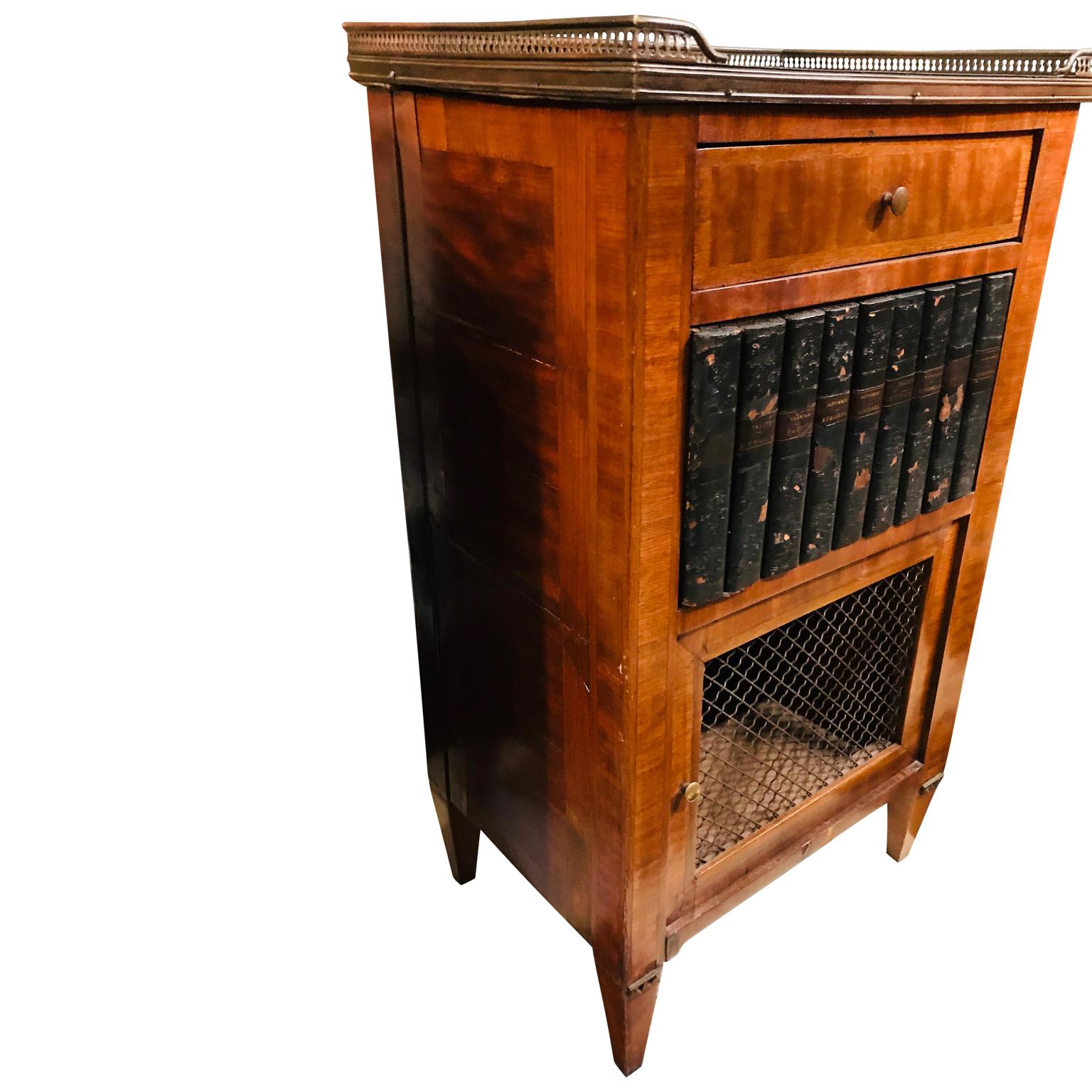 Pair of french marble top library themed side cabinets with leather backed book and brass decor.


  