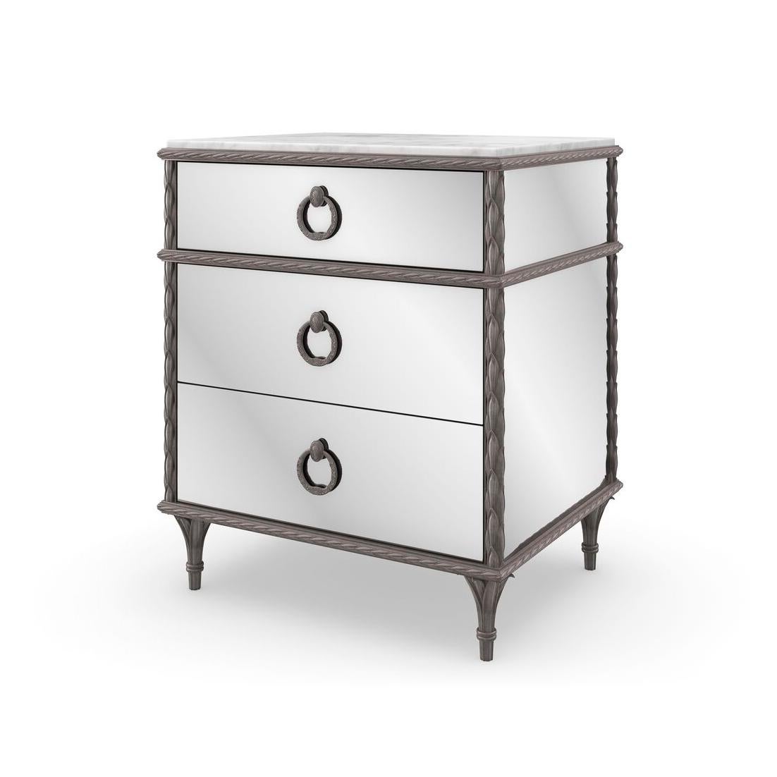 This exquisite nightstand features mirrored front and end panels that reflect light beautifully, adding a touch of glamour and spaciousness to any room.

Standing on cast aluminum legs with intricate cast moldings finished in a sophisticated Sea