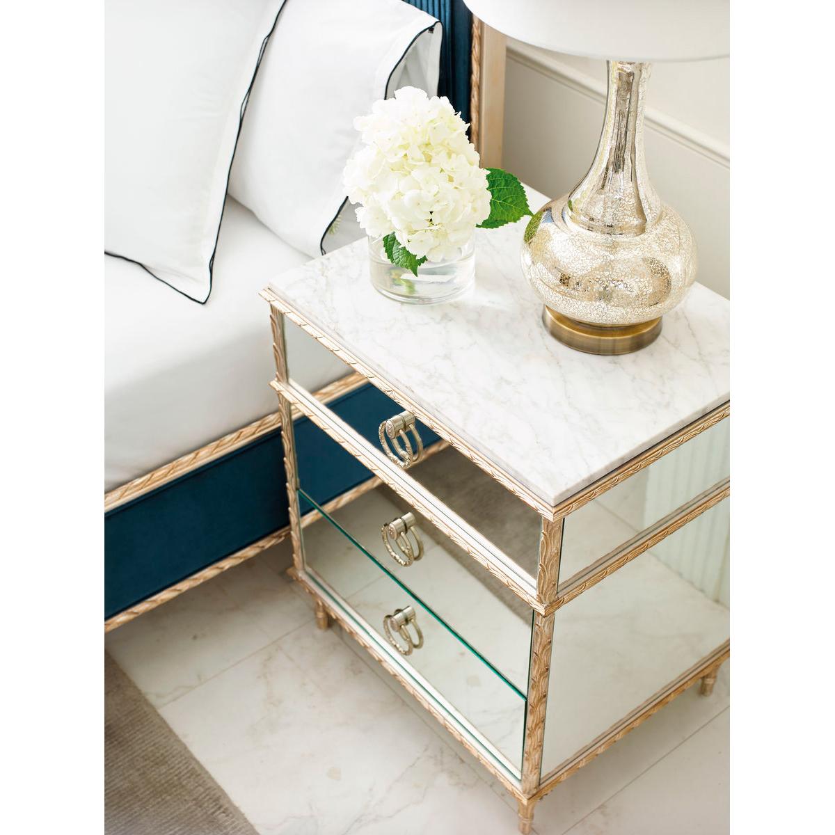 This exquisite nightstand features mirrored front and end panels that reflect light beautifully, adding a touch of glamour and spaciousness to any room.

Standing on cast aluminum legs with intricate cast moldings finished in a sophisticated gold
