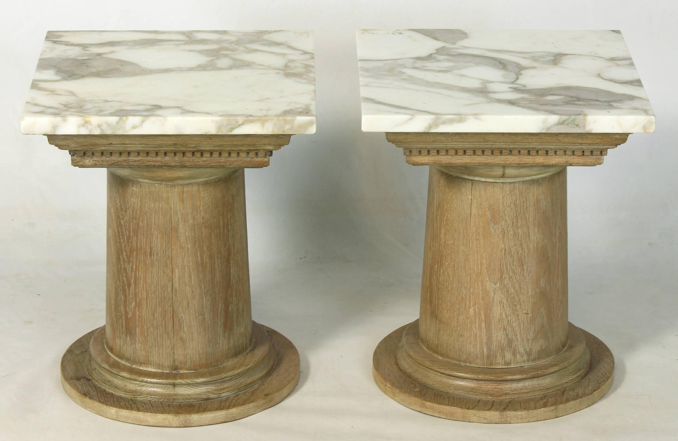 A pair of mid-20th century. French limed oak column-form side tables with square marble tops.