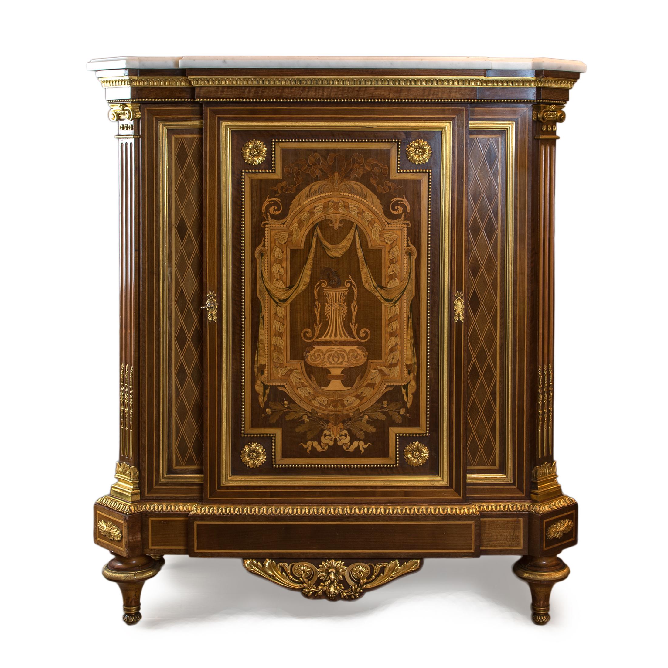 Attributed to Mathieu Befort Jeune (1813 - 1880)

Circa 1870, In a Louis XVI Style. The white marble tops above a conforming case, the doors inlaid with a stylized urn, centered by ribbon-tied leaves, the door flanked by panels inlaid with a