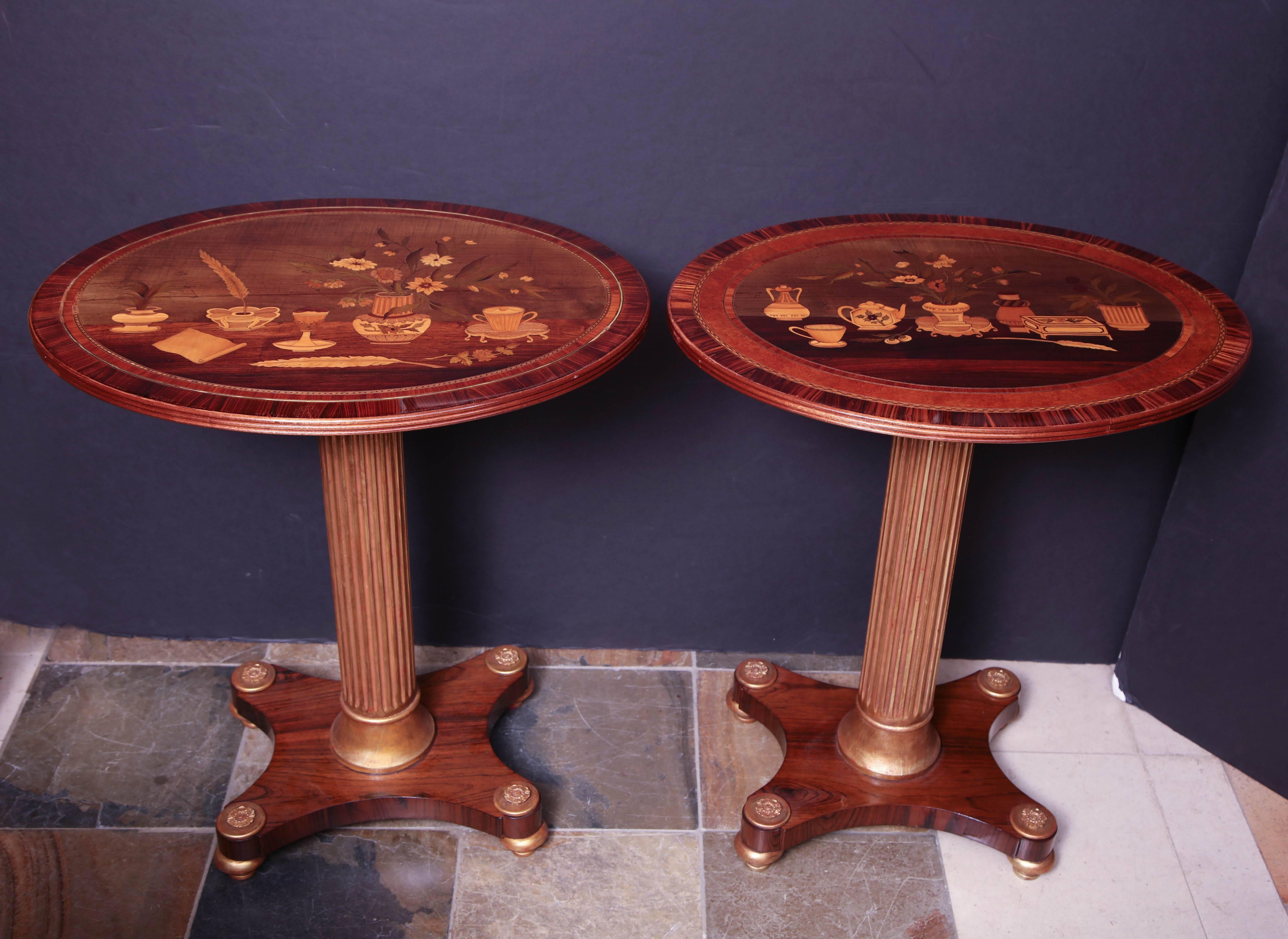 An unusual pair of French neoclassic marquetry oval panel top side tables with gilded fluted pedestal bases.
