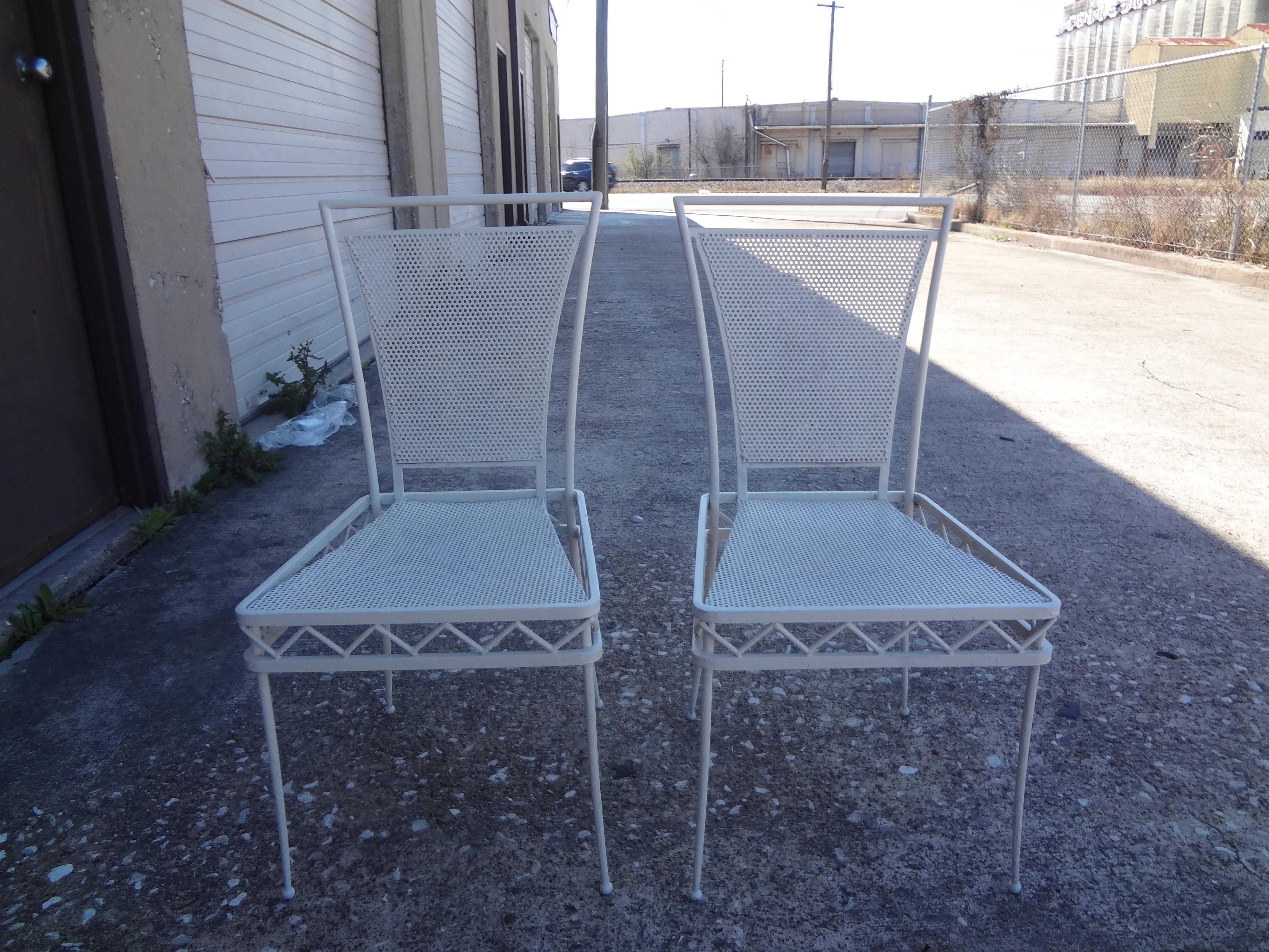 Pair of French Mathieu Matégot style white wrought iron chairs. These stunning French Rivera iron chairs can be used indoors or outdoors as garden chairs.
They are white. The photograph looks a bit light blue.
These chairs could easily be painted in