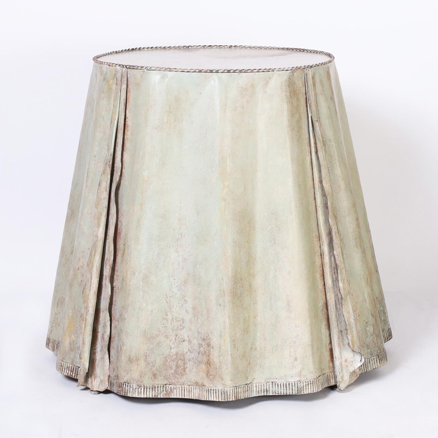 Sophisticated pair of French tables or stands crafted with metal over a sturdy metal frame in a chic industrial ghost drapery form. The original putty green finish is oxidized and worn to perfection. Best of the genre.

Top diameter is 22