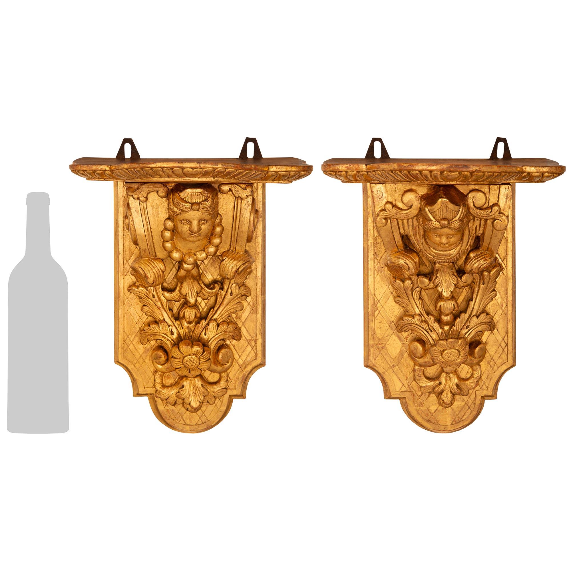 A handsome pair of French mid 18th century Regence Period Giltwood wall brackets. Each wall bracket is set on a rectangular backplate displaying a lattice design. Wonderful and richly detailed foliate carvings lead up the front center of each