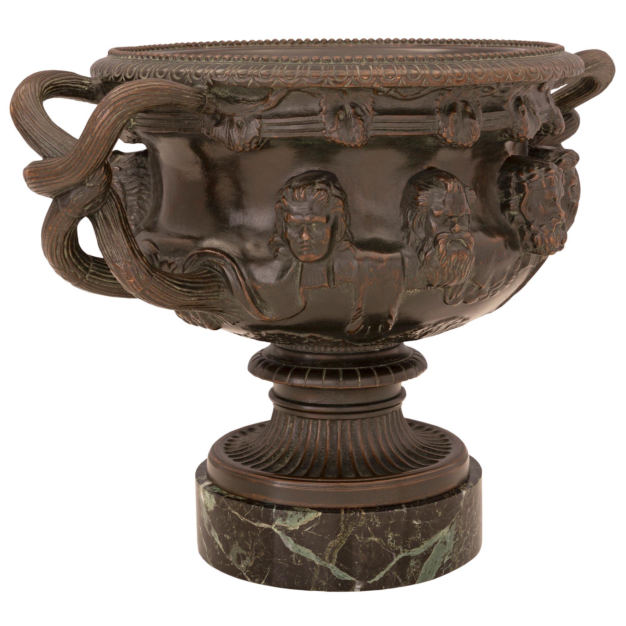 A handsome pair of French 19th century patinated bronze and Vert de Patricia marble tazzas, signed F. Barbedienne and after the renowned Albani vase. Each tazza is raised by a circular Vert de Patricia marble base below the fluted patinated bronze