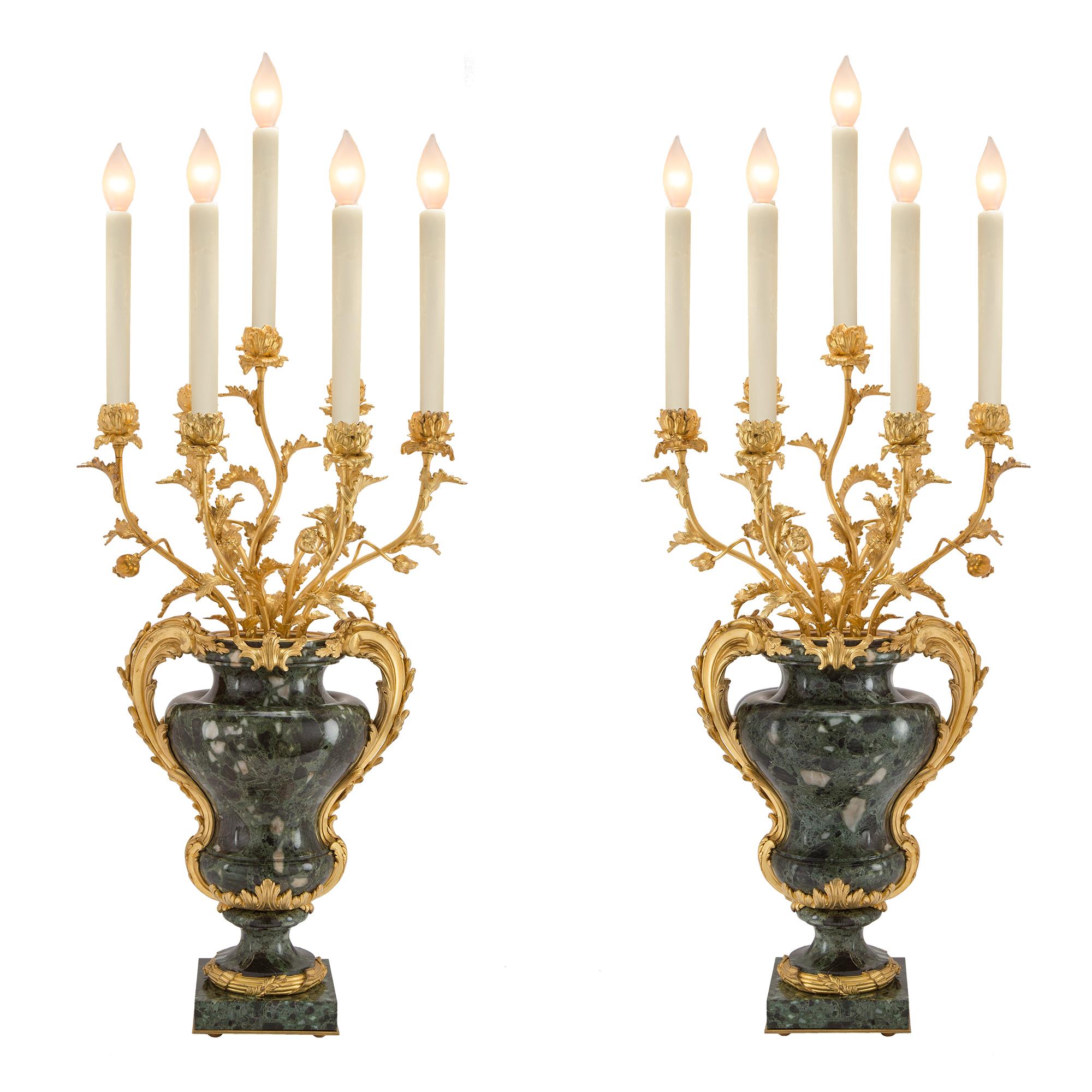 A most important and impressive large scale pair of French mid 19th century Louis XVI st. Vert Antique of Greece marble and ormolu mounted seven arm candelabras. Each candelabra is raised by a square marble base decorated by a laurel chased ormolu