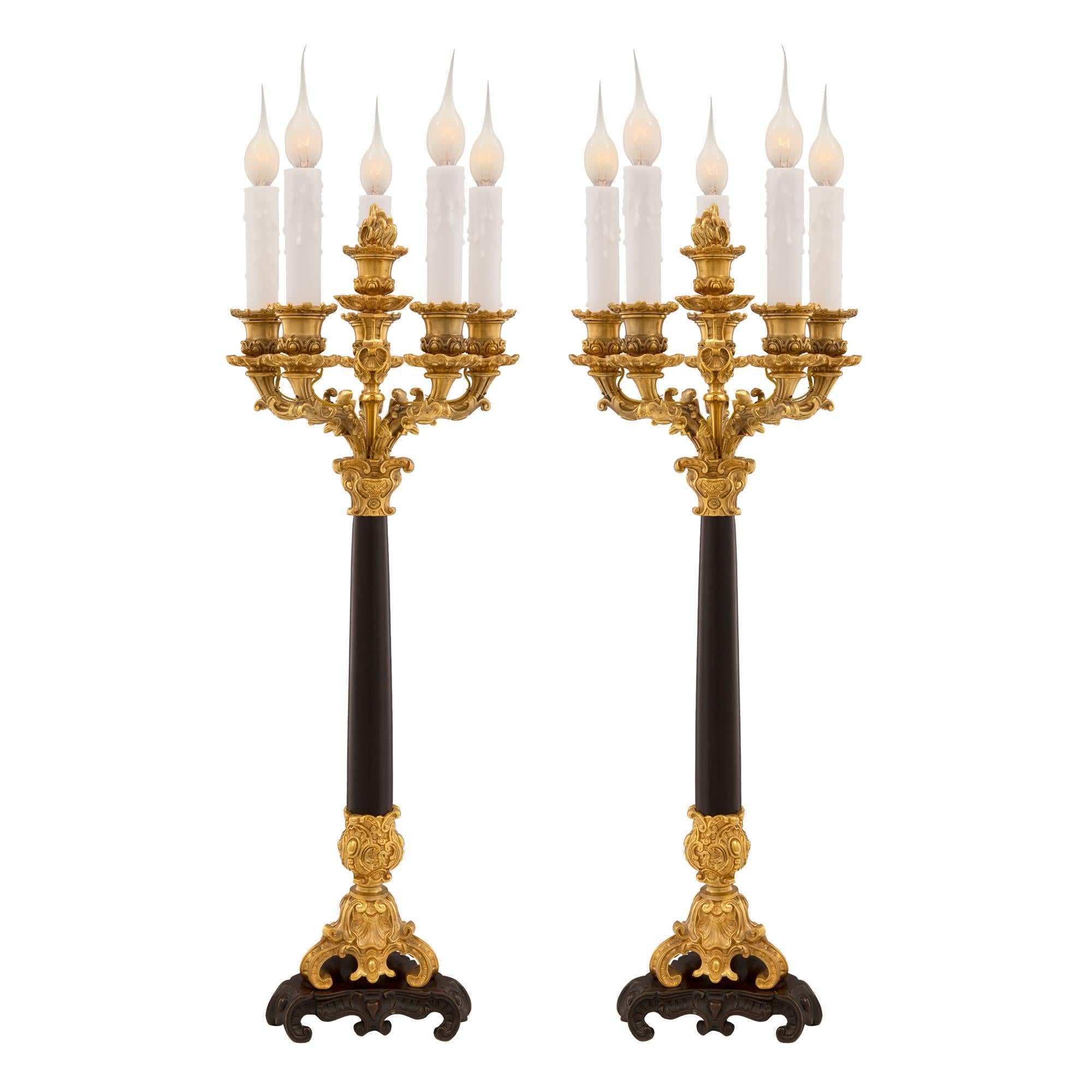 A most impressive and high quality pair of French mid 19th century neo-classical st. patinated bronze, ormolu and black Belgian marble five arm candelabras lamps. Each lamp is raised by a triangular patinated bronze and ormolu stepped base with
