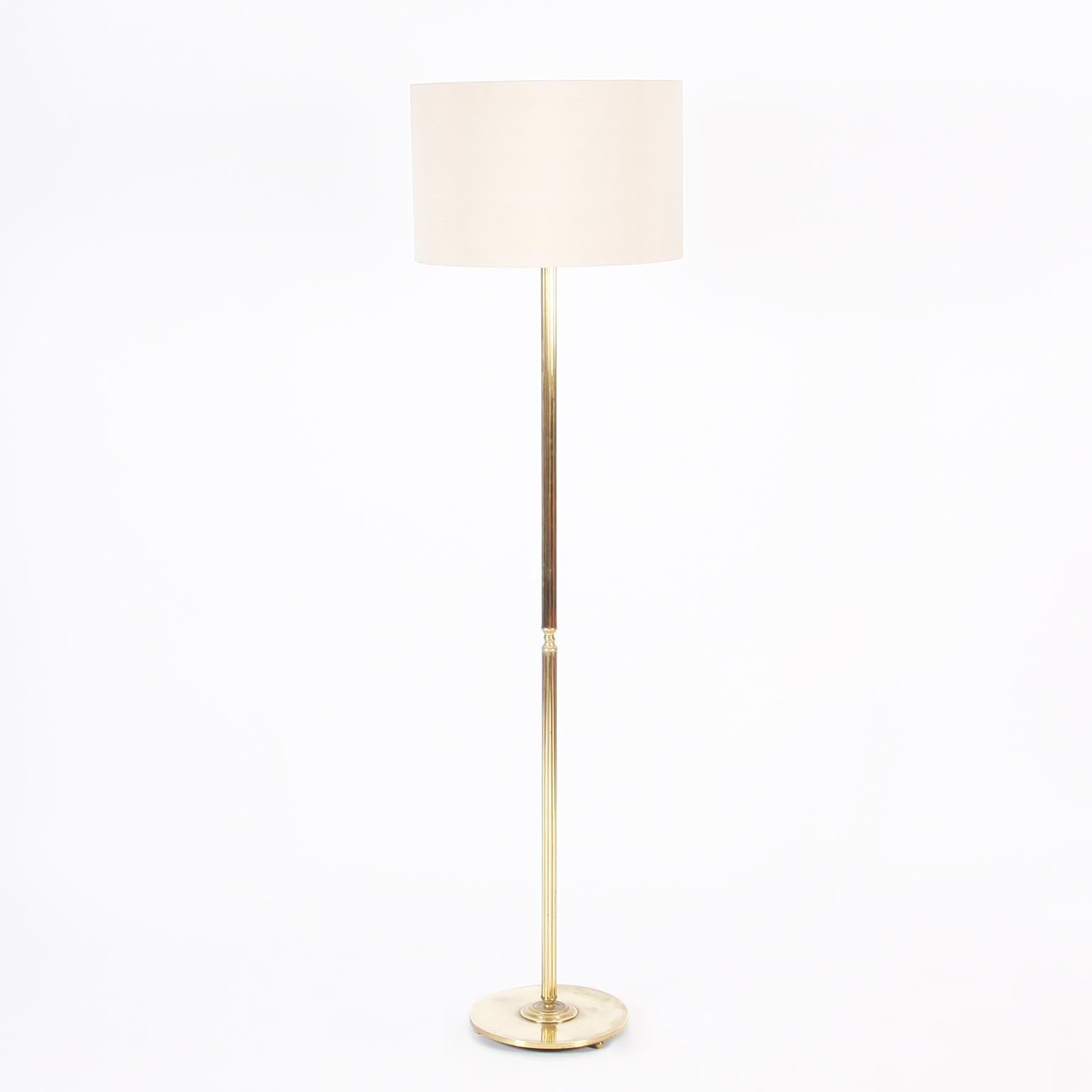 French Mid-20th century

A stunning pair of brass floor lamps, with reeded stems and round disk bases, on three spherical feet. 

Rewired and PAT tested. With twisted, black, silk flex. 

Pictured with handmade, bespoke, silk shades.