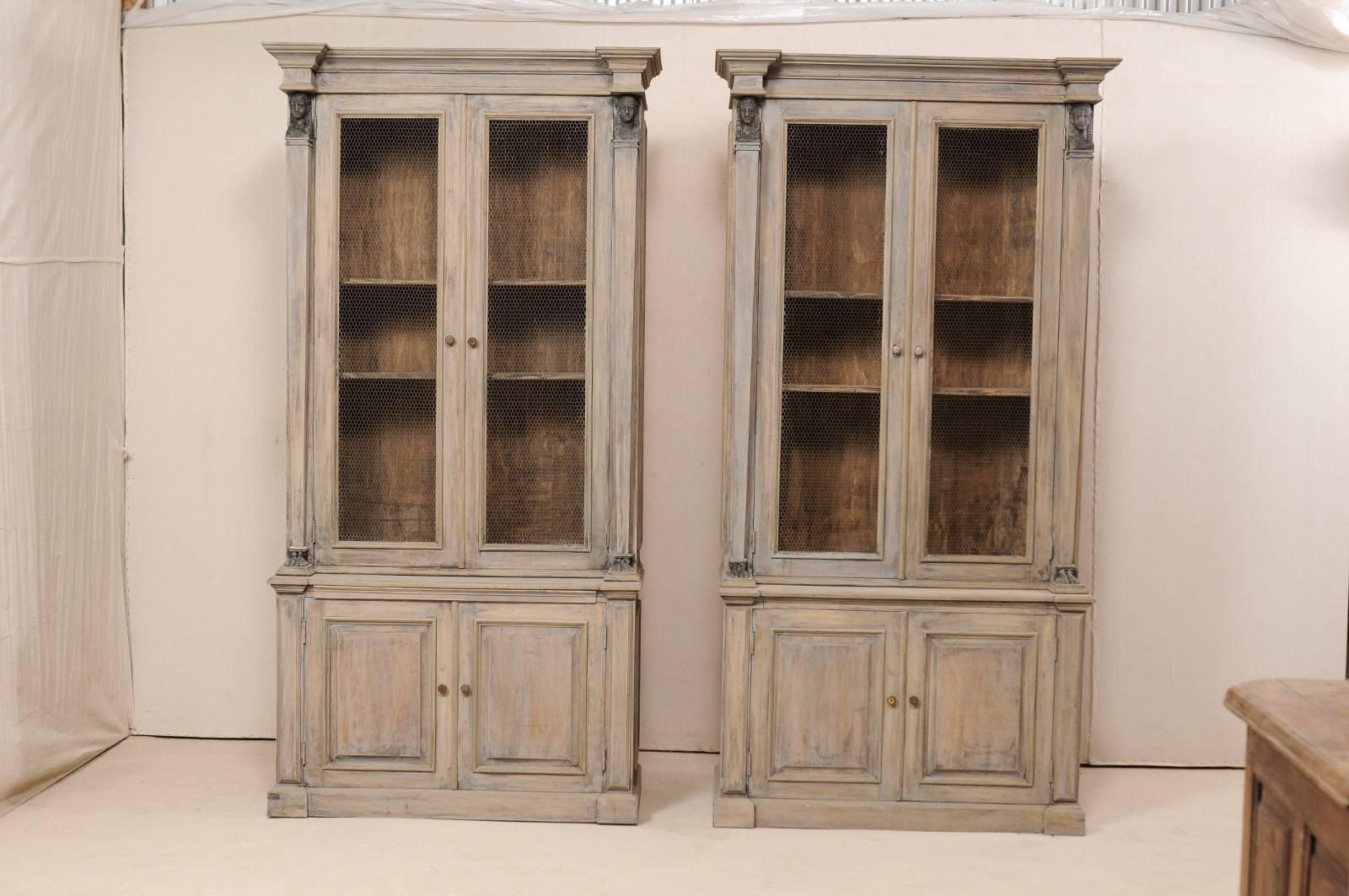 A pair of French mid-20th century tall neoclassical style cabinets. These vintage French buffet à deux-corps (which is the name for a French buffet consisting of an upper and lower case, 