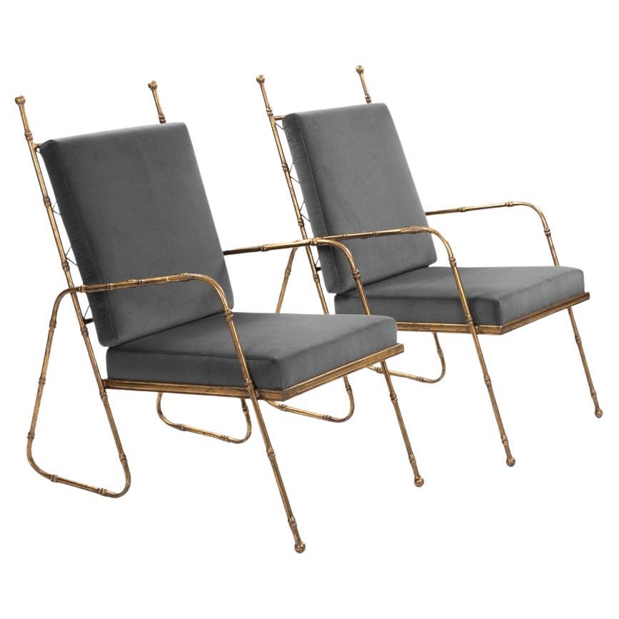 Pair of French Mid-Centruy Gilt Iron Faux Bamboo Armchairs Grey Velvet 1980s

Light-footed and stylish armchairs in bamboo design.
The eccentric design of the rear foot, almost like a loop, which then merges seamlessly into the armrest and flows out