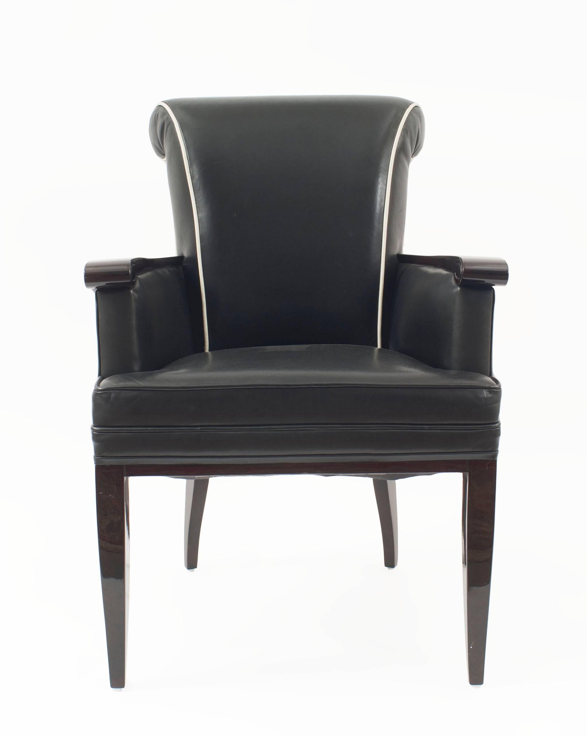 Pair of French Mid-Century dark rosewood stained oak bergere Armchairs with a rolled back and and carved scroll arm upholstered in black leather with white piping (by JEAN PASCAUD) (PRICED AS Pair)
