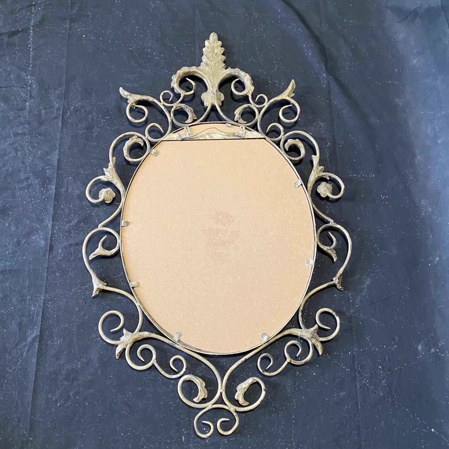 Pair of French Mid Century Fleur de Lis Scrolled Oval Beveled Wall Mirrors For Sale 4