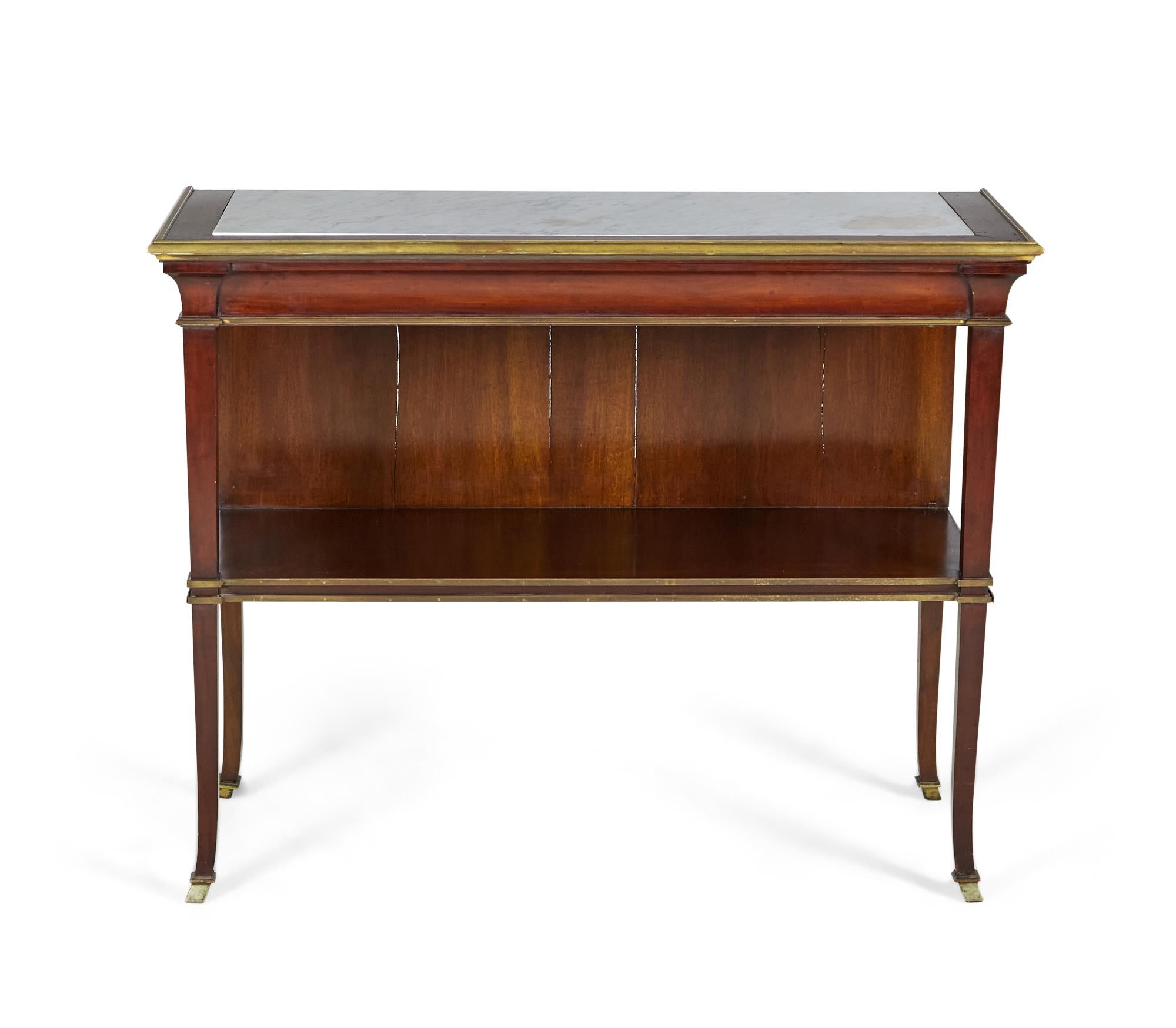 Pair of French mid-century Louis XVI style (circa 1940s) mahogany console tables having a solid back ending in a shelf with a white inset marble top and bronze trim and sabots (manner of MAISON JANSEN) (priced as pair).
        