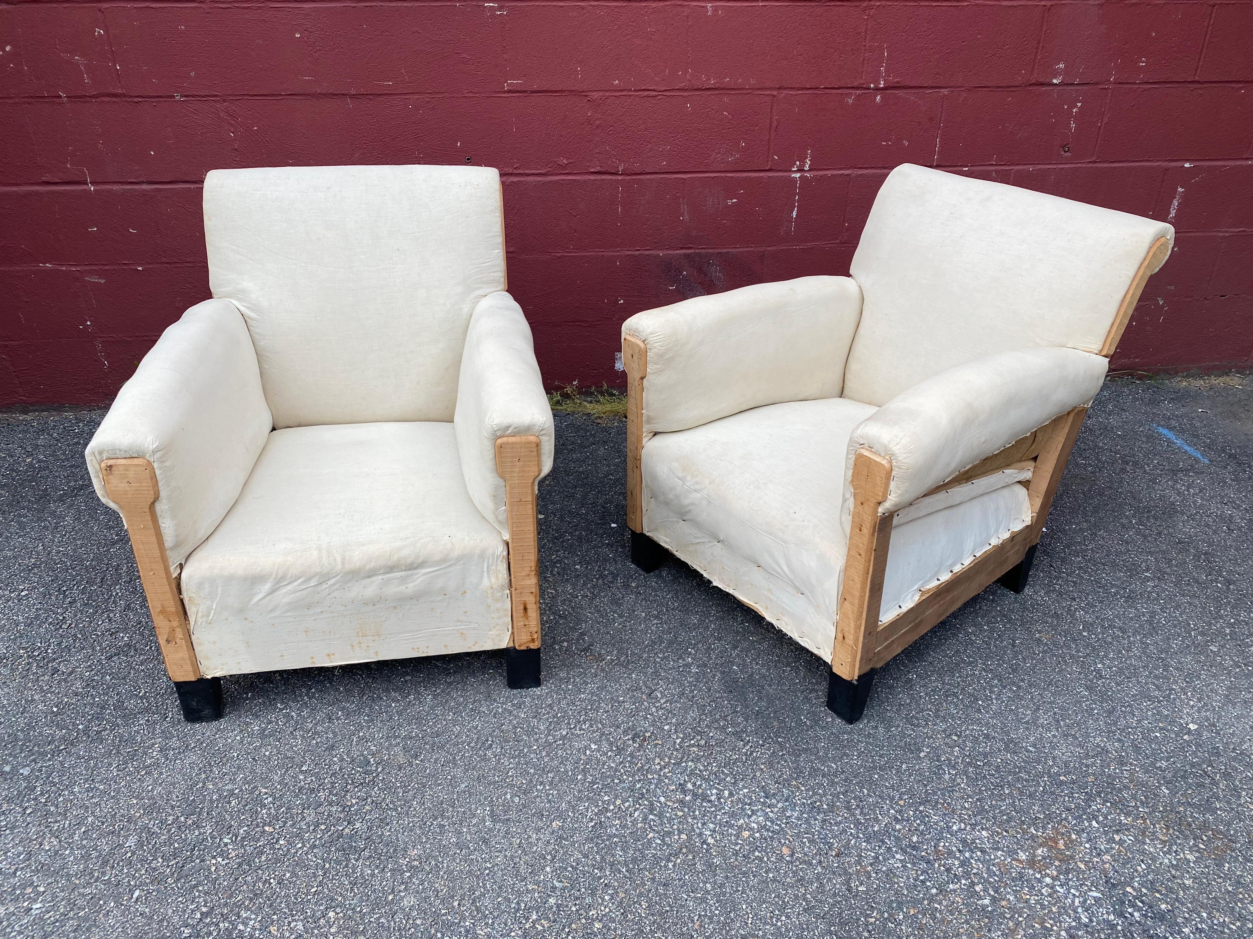 A handsome pair of French club chairs that have been stripped down to the muslin and are ready to be upholstered.  The small scale armchairs are very comfortable for their size and with the right upholstery job they will be stunning. (We always