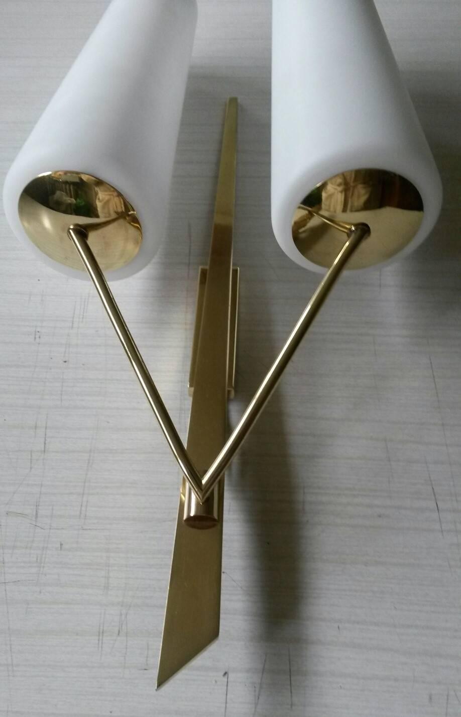 French pair of double sconces by Lunel in gilt bronze and two satin white opaline glasses. 
Large size, circa 1950.

In an excellent original condition.
He electric part has been renewed. (Max 60 watts each bulb).

Dimensions:

Height 57