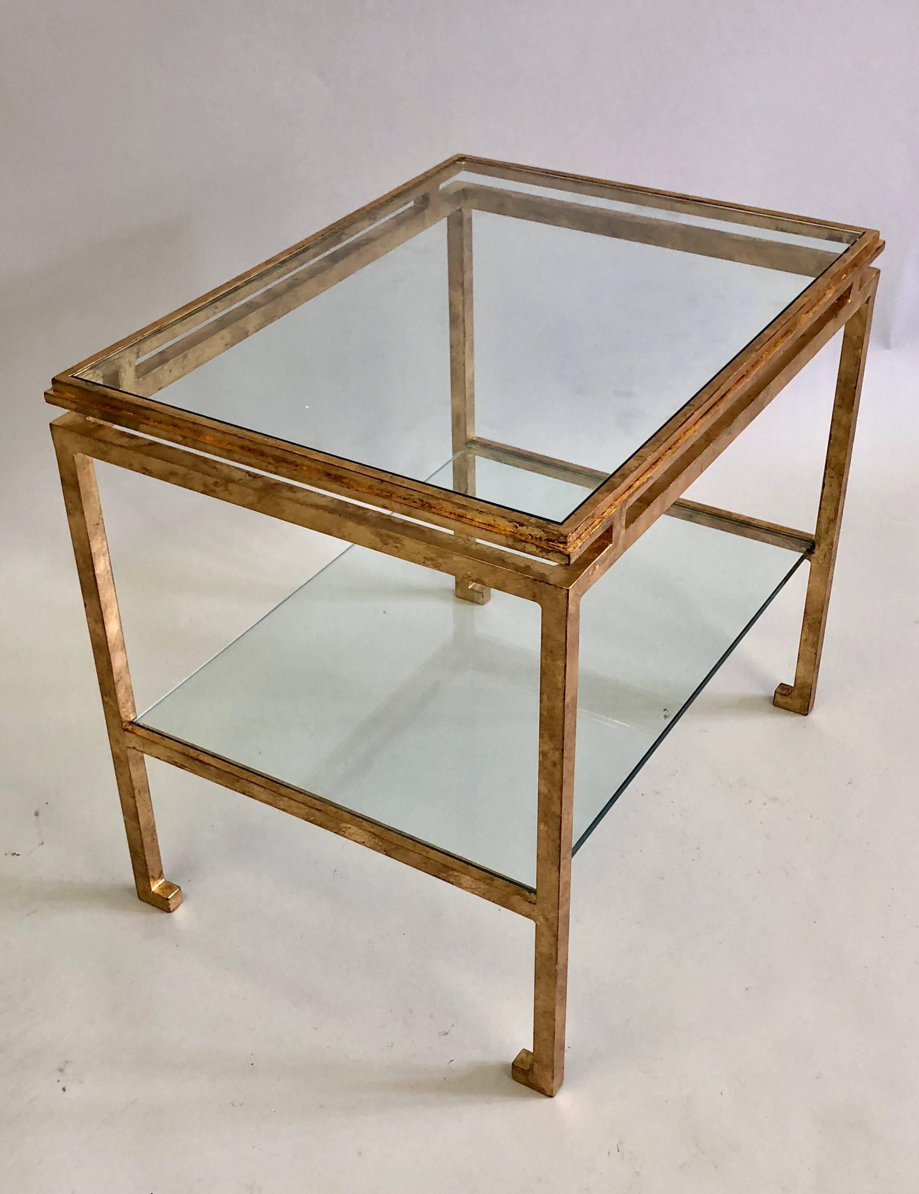 Elegant, timeless pair of French Mid-Century Modern neoclassical gilt iron side / end tables by Maison Ramsay, 1940-1960.

These chic double level tables feature elegant, seem-less detailed construction, the Classic Ramsay turned in feet and