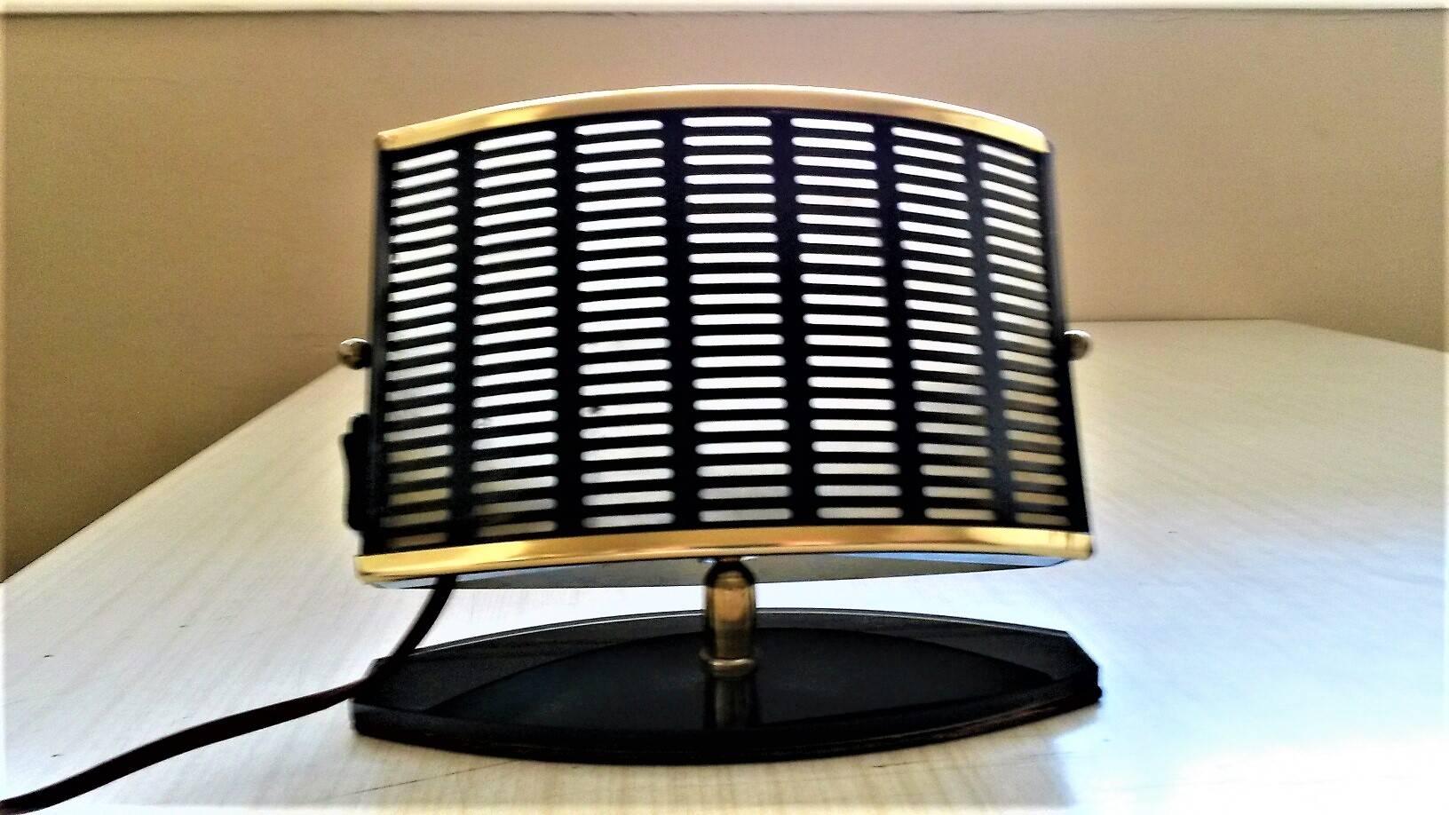 Pair of French Mid-Century Modern table side lamps.
Made in perforated Black sheet metal and gilt metal on a black opaline glass base. One in white lacquer and the other in black lacquer inside decoration. By Aluminor, in the style of Jacques Biny,