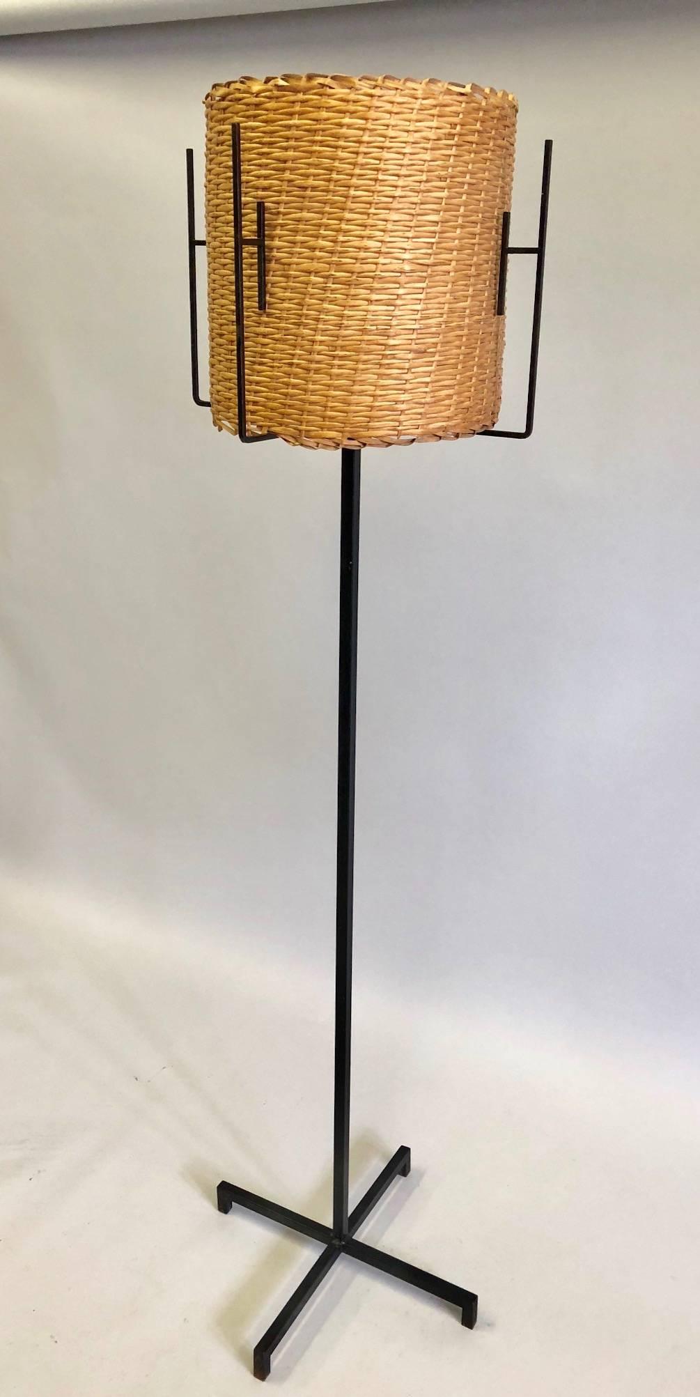 Rare pair of French Mid-Century Modern enameled wrought iron standing lamps by Disderot. 

The floor lamps feature a modern neoclassical X-form base supporting a sleek stem from which emanates minimalist architectural brackets that elegantly encase