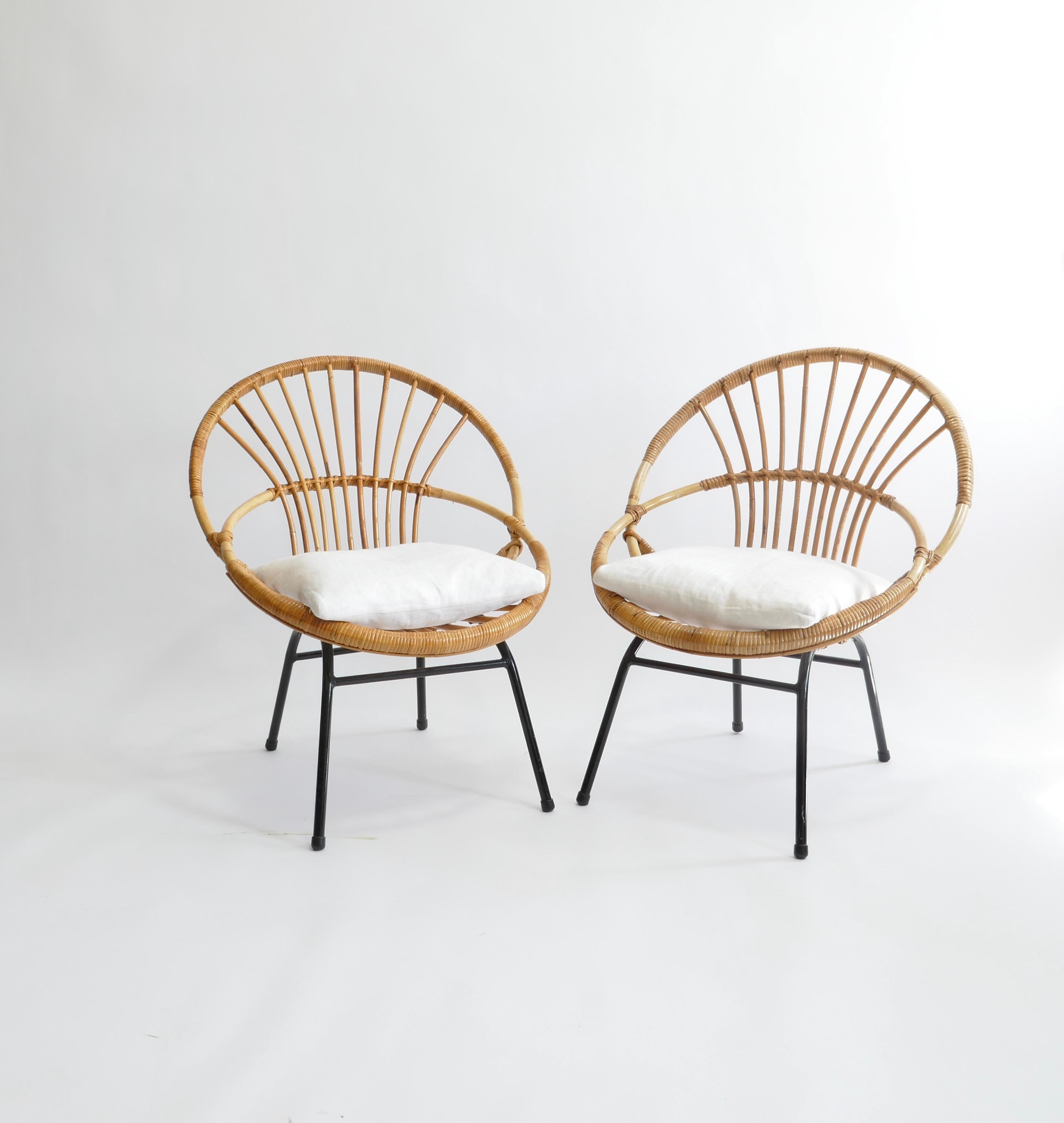 Very nice sculptural rattan lounge chairs made in France, 1950s. 
The chairs have a solid steel frame, black painted and rattan handwoven seat. 
Easy to place them they are very comfortable especially with a cushion on.
 