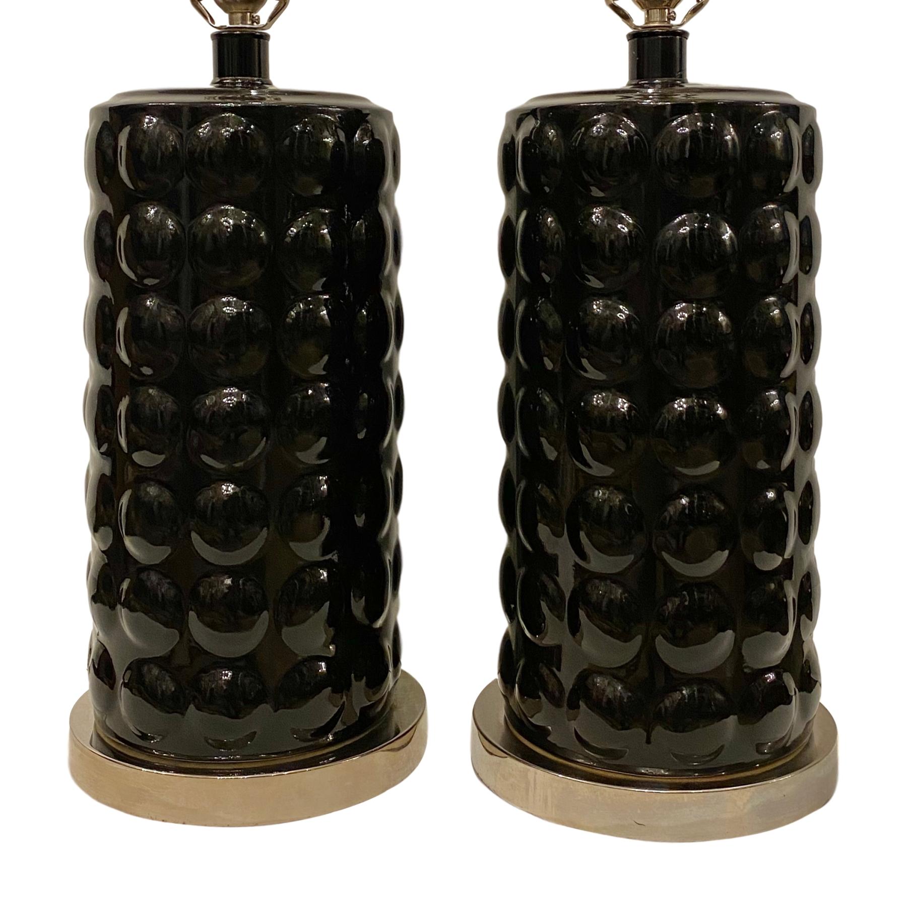 A pair of French circa 1960's moderne glazed black porcelain lamps.

Measurements:
Height of body: 16