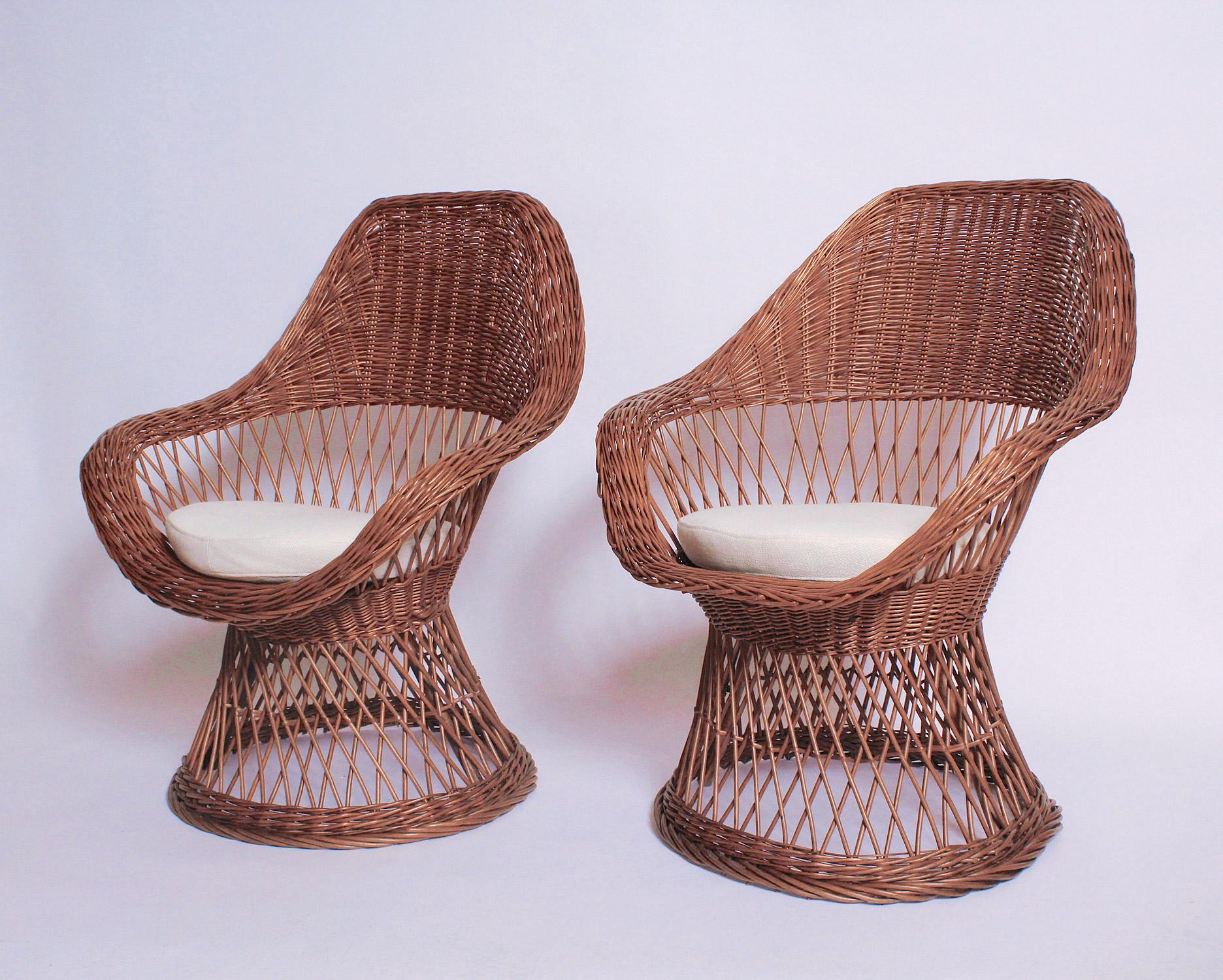 Lightweight pair of French Mid-Century Modern woven wicker lounge chairs with new cushions, upholstered in an off-white linen/cotton blend.