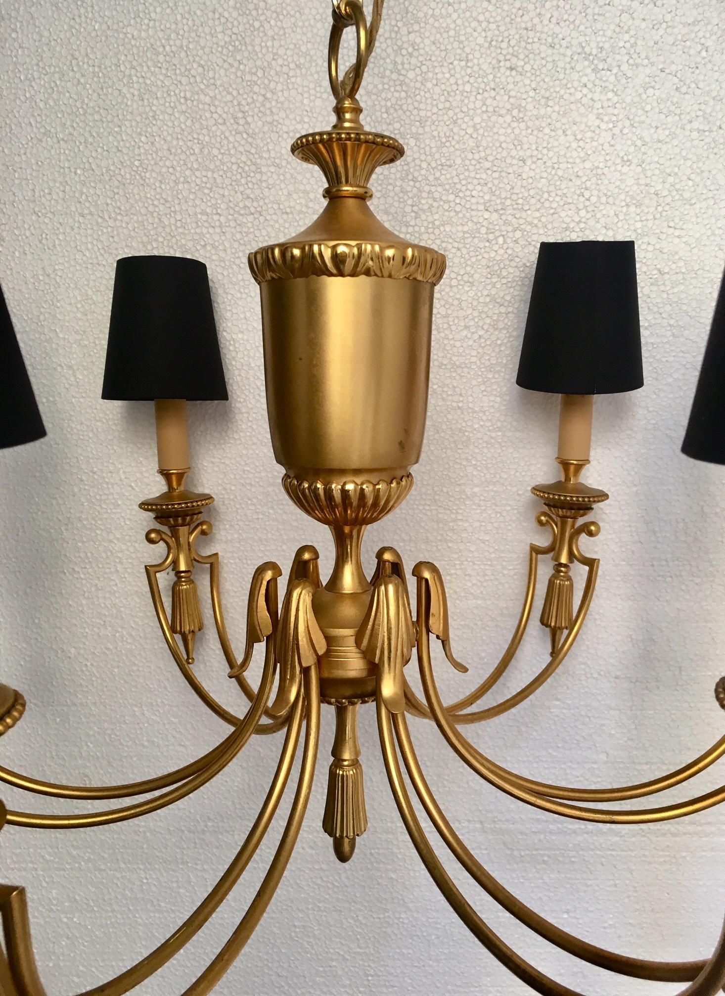 Mid century chandeliers, gold metal with six arms, shedes in black and gold.