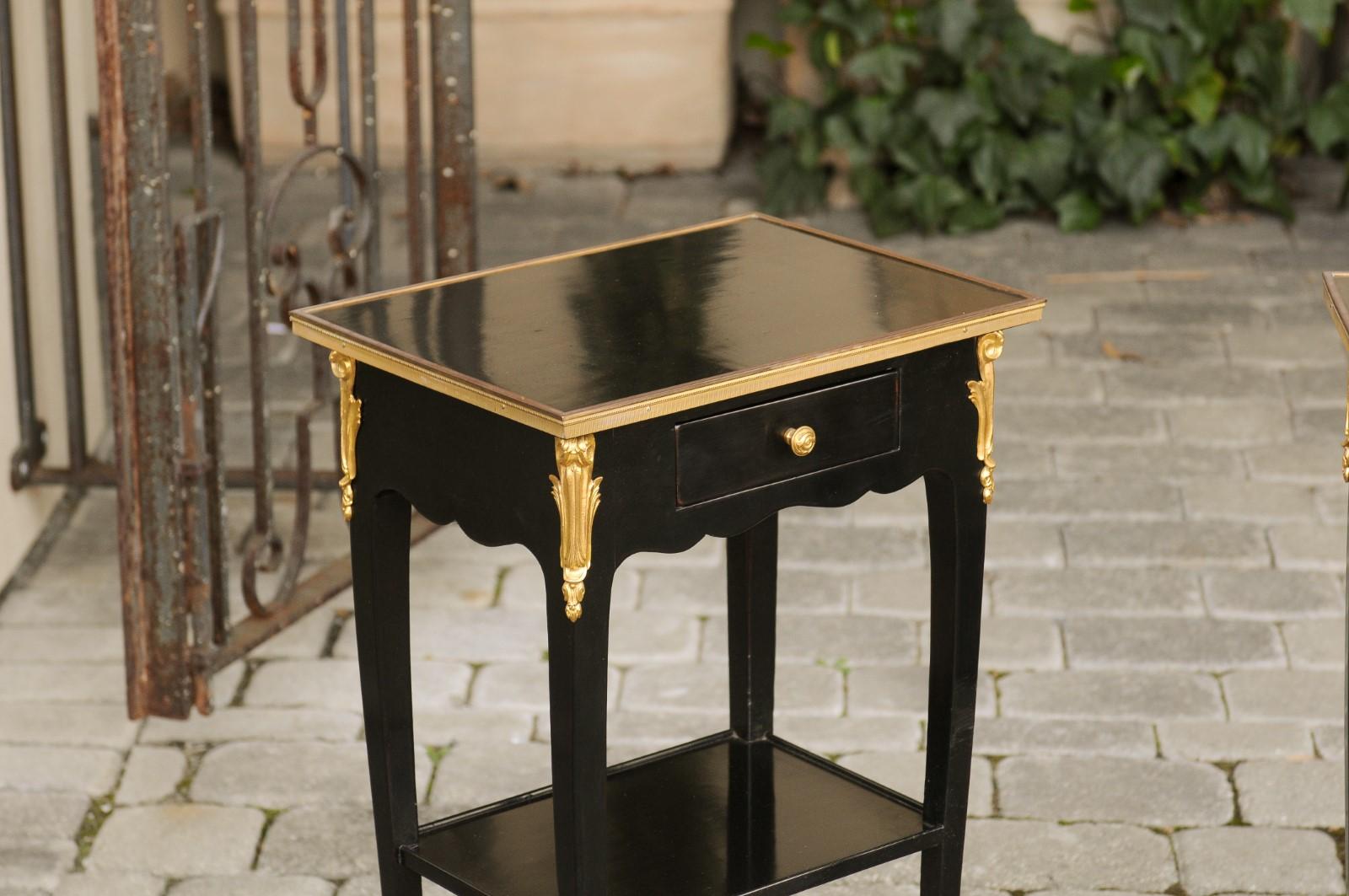 20th Century Pair of French Midcentury Ebonized Tables with Ormolu Mounts, Drawer and Shelf For Sale