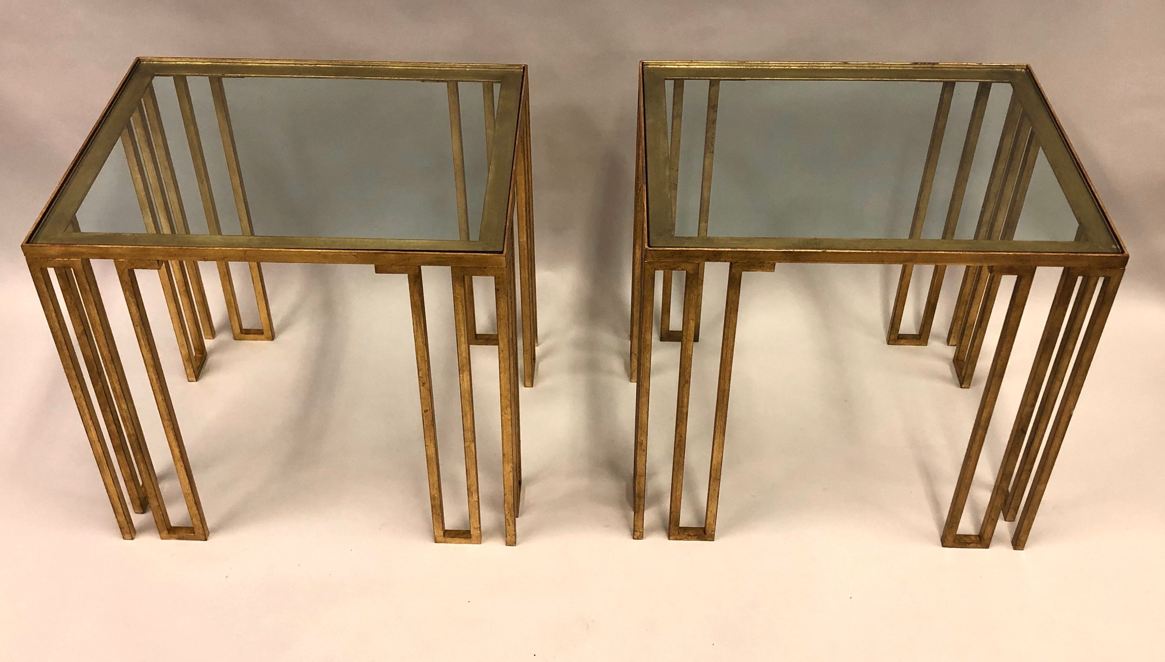 Elegant and rare pair of French Mid-Century Modern Neoclassical side or end tables in hand gilt wrought iron attributed to Jean Royère. The 'Creneaux' tables are classic, modern pieces featuring a geometric, rhythmic pattern with open, slotted