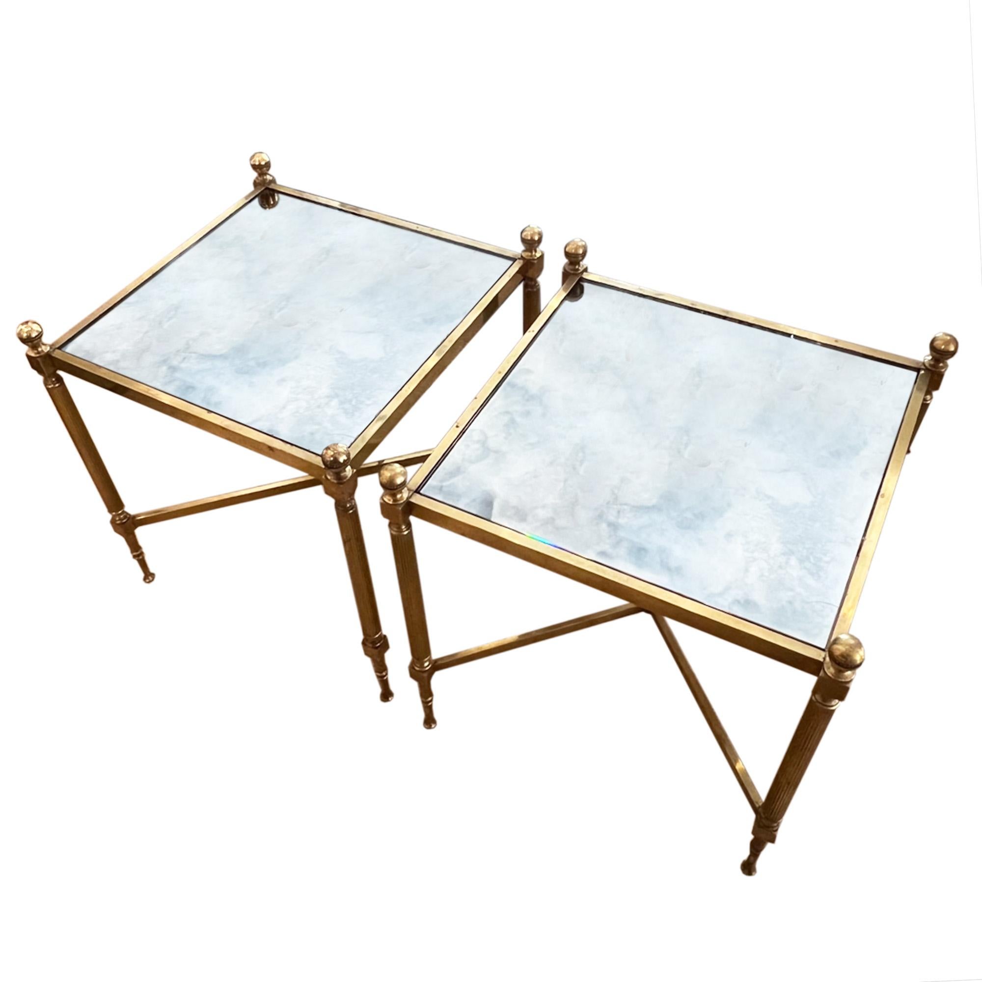 A good pair of midcentury side tables, made in France in the 1960s. 

Please take a look at all our photos to see the detail on the brass frames - from the spherical finials to the reeded columns. 

Beautiful eglomise glass gives a luxurious finish.