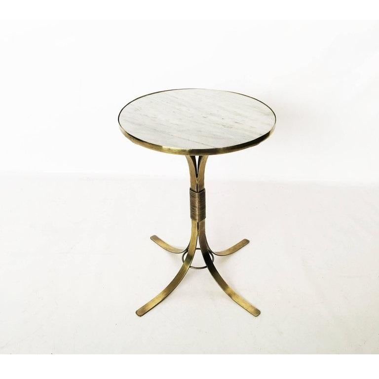 Pair of French Mid-Century Modern neoclassical gueridons / end tables / nightstands. This design bears a stylish classical inspiration. Inset white marble top rests on a splayed leg base banded together by a number of rings at the center allows for