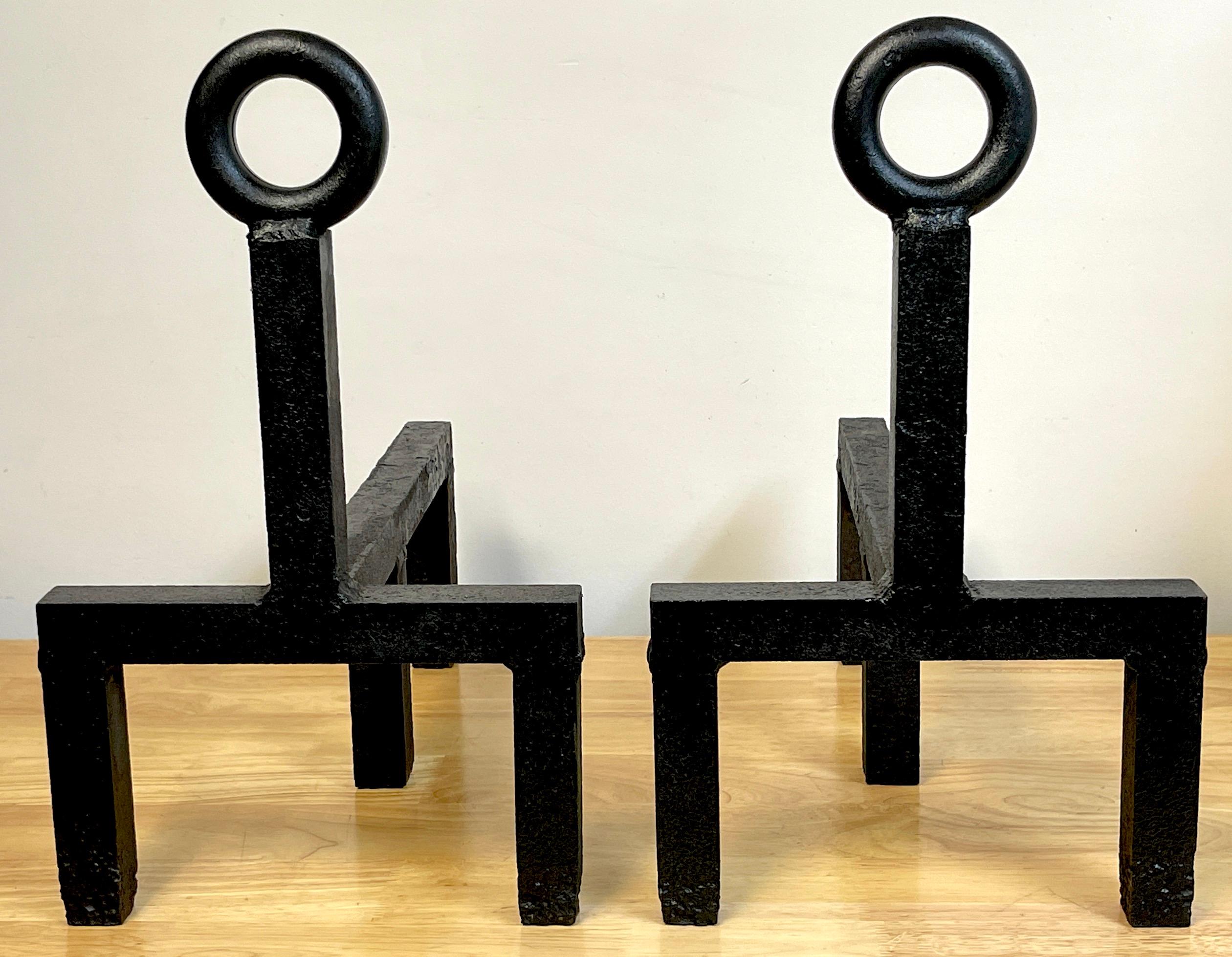 Pair of French Modern 'Keyhole' forged iron andirons 
Each one of typical form forged of substantial 1.5-Inch thick iron, with ring tops resting on straight columnar two-legged base
Each andiron stands 17- Inches high x 10.25 -inches wide, with