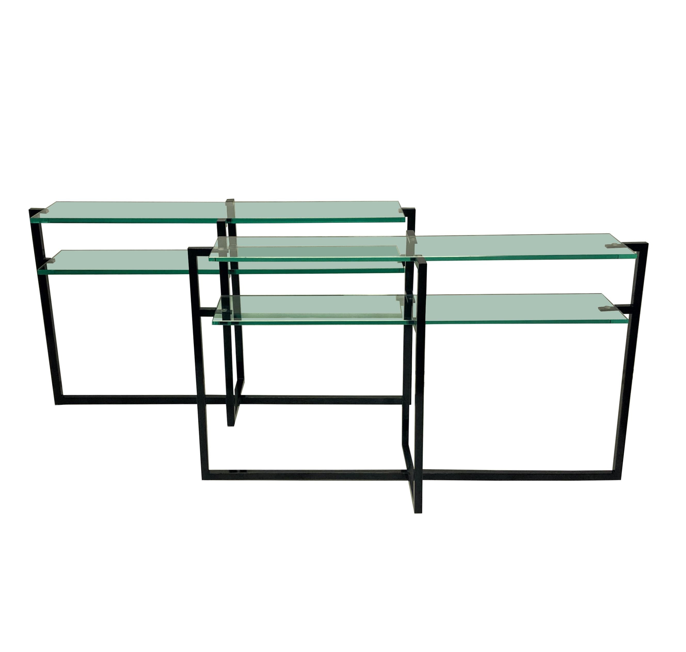 A matched pair of French Modernist console tables, in black hand lacquered steel, each with double shelves in thick plate glass.
