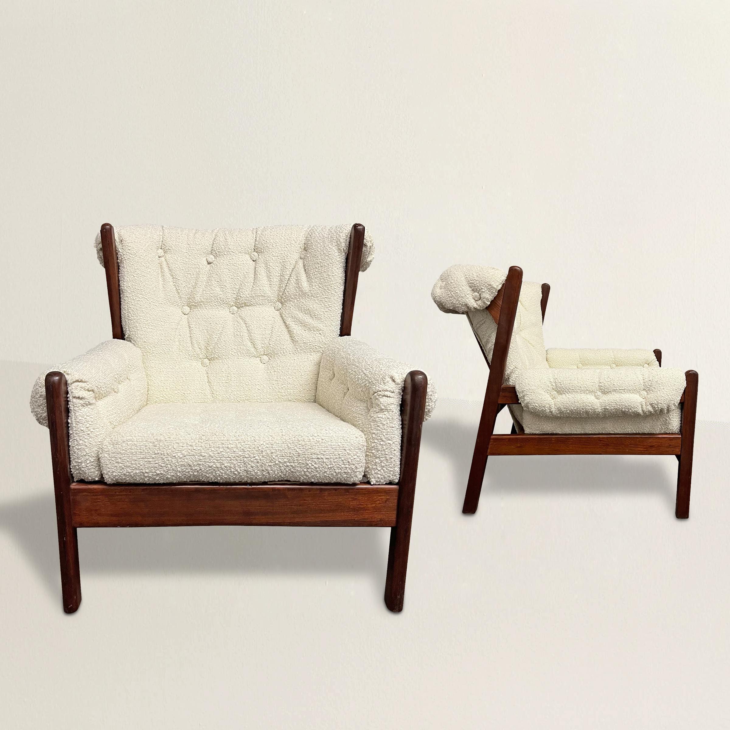 Experience the pinnacle of French modernist design with this stunning pair of mid-20th century lounge chairs, refreshed with new chunky tufted wool bouclé upholstery. These chairs epitomize modernist aesthetics with their sleek lines, creating a