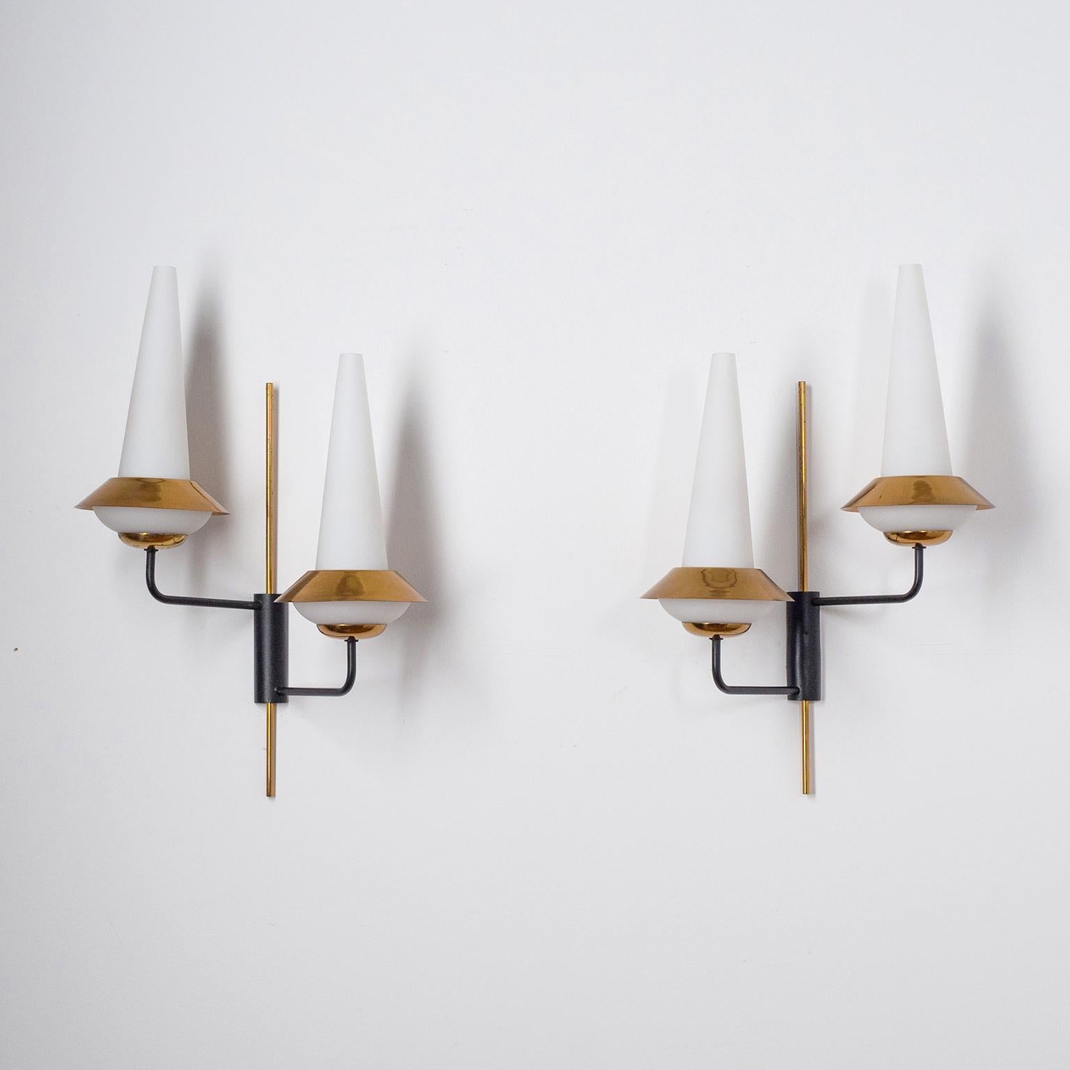 Rare pair of French two-arm wall lights from the 1950-1960s. A Minimalist brass and lacquered structure with two satin glass diffusers and polished brass shades. Brass and ceramic E14 sockets with new wiring. Priced and sold as a pair.