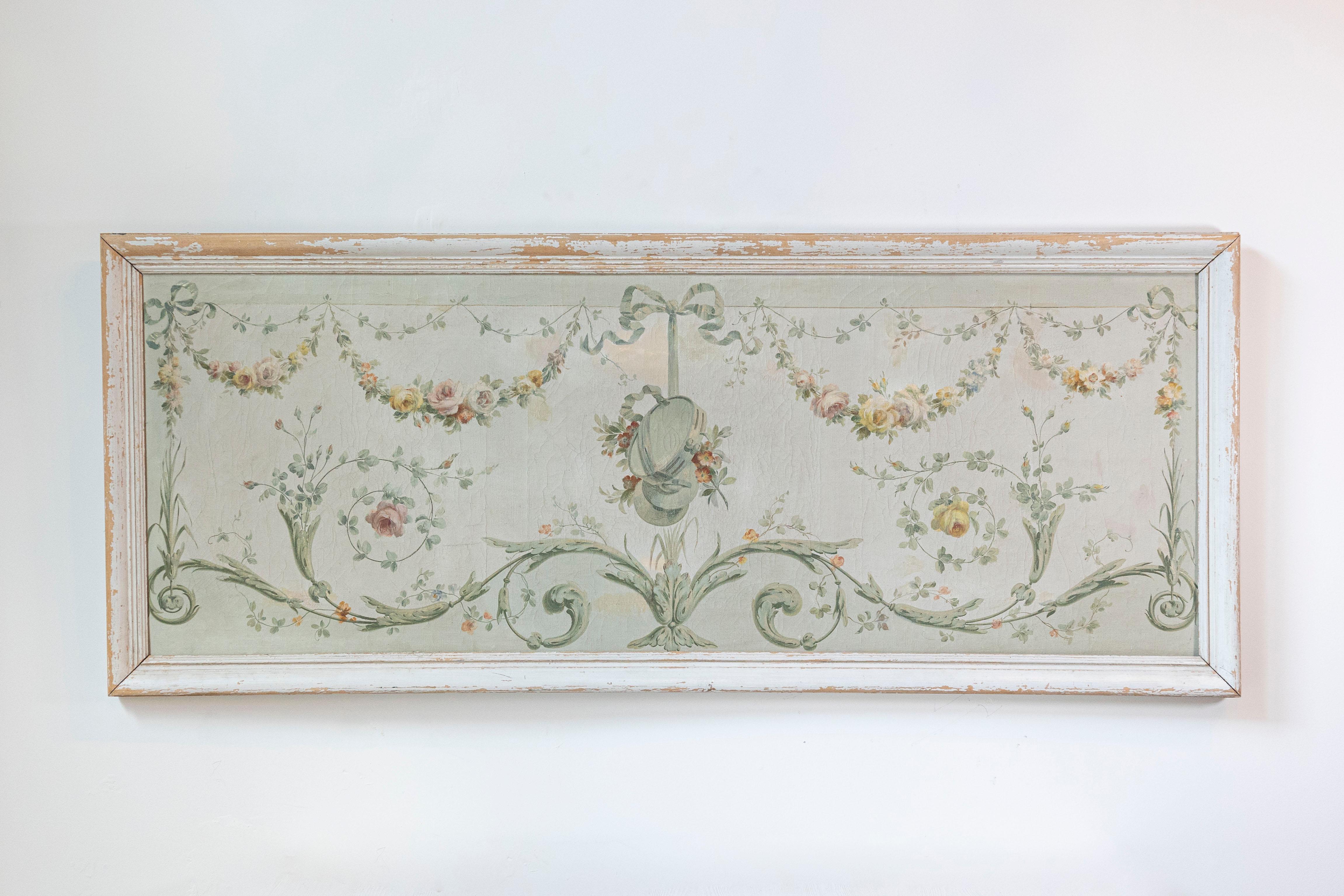 A pair of French Napoléon III period oil on canvas overdoor panels from the mid 19th century, with floral garlands and ribbon-tied musical instruments. Created in France during the third quarter of the 19th century, each of this pair of oil on