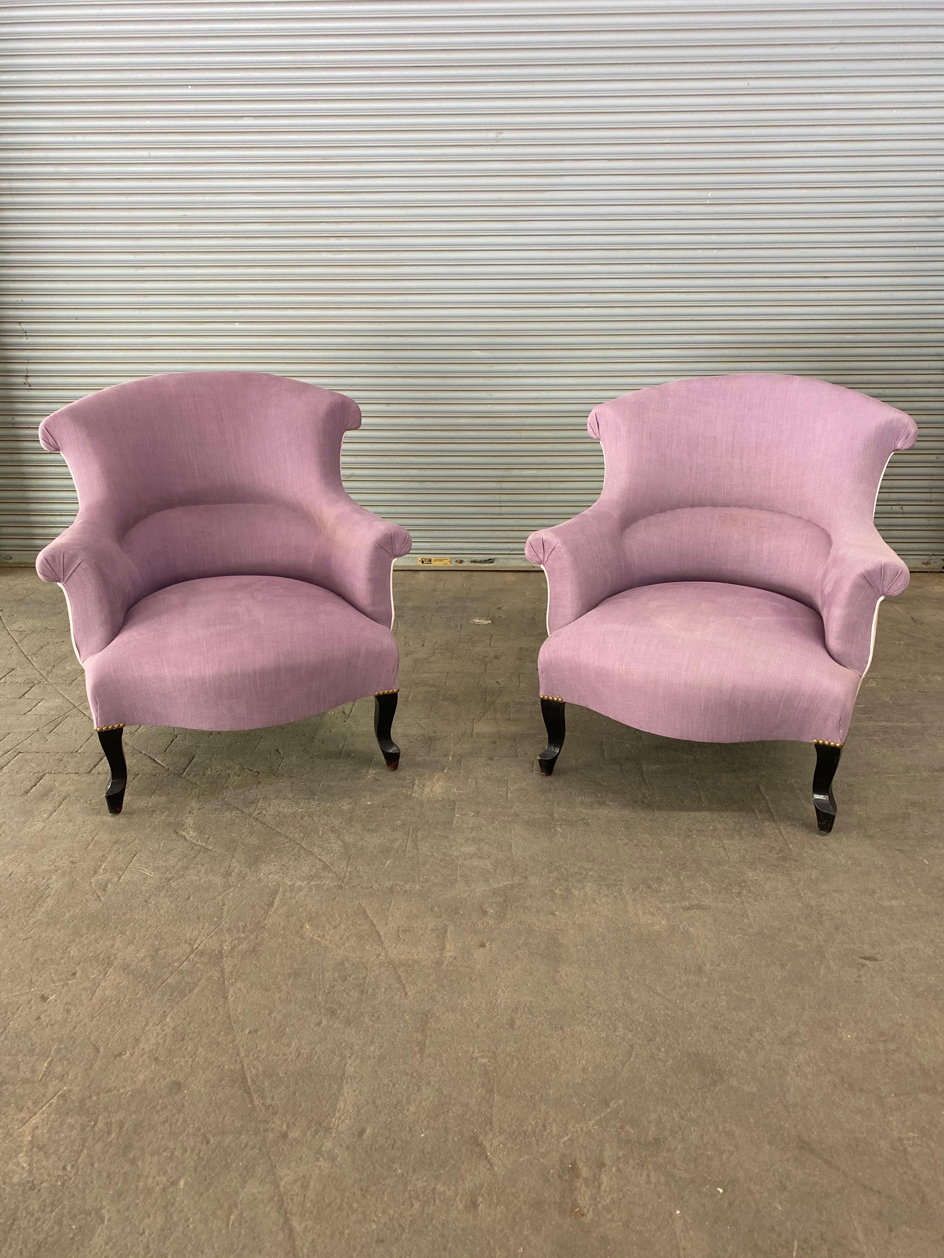 A pair of French 19th century Napoleon III armchairs upholstered in lavender linen with a contrasting back panel. The armchairs are in very good vintage condition, and while the upholstery is not new, the fabric is clean and can be used. Sold in